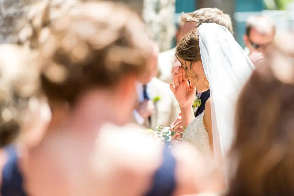 Praying during an Our Lady of Lourdes Denver wedding.