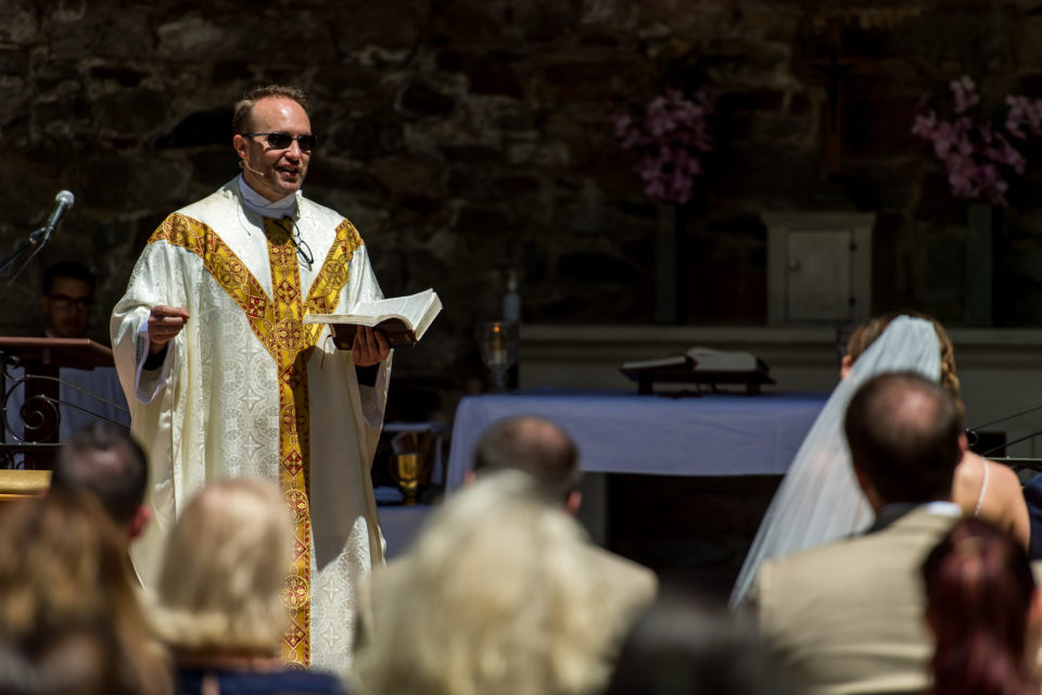 Fr. Brian Larkin preaches during an Our Lady of Lourdes Denver wedding.