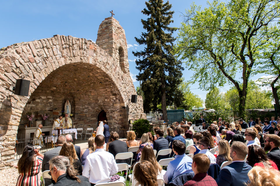 Celebrating Mass during an Our Lady of Lourdes Denver wedding.