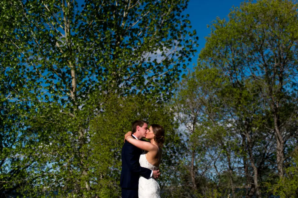 Bride and groom pose during a backyard wedding in Colorado