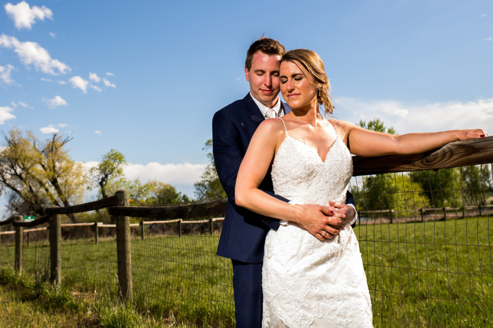 Bride and groom pose during a backyard wedding in Colorado