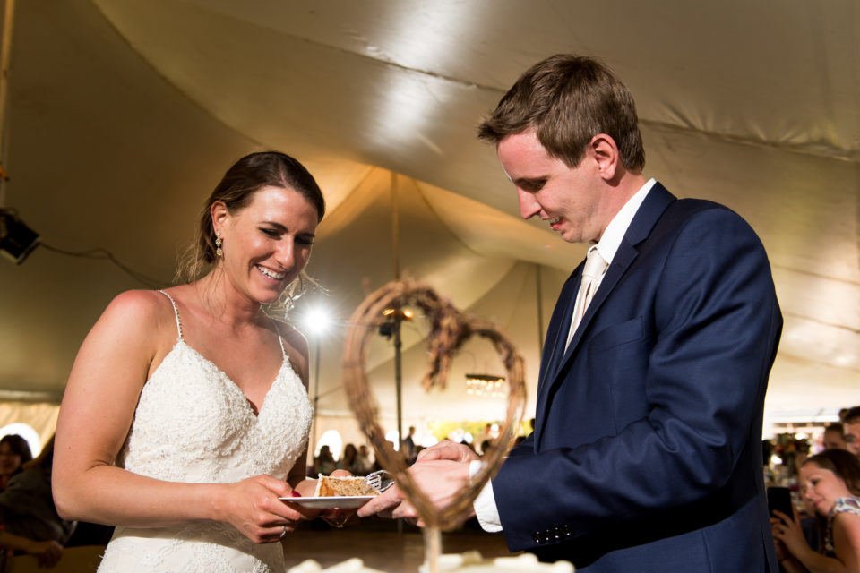 Bride and groom cut the cake during a backyard wedding in Colorado