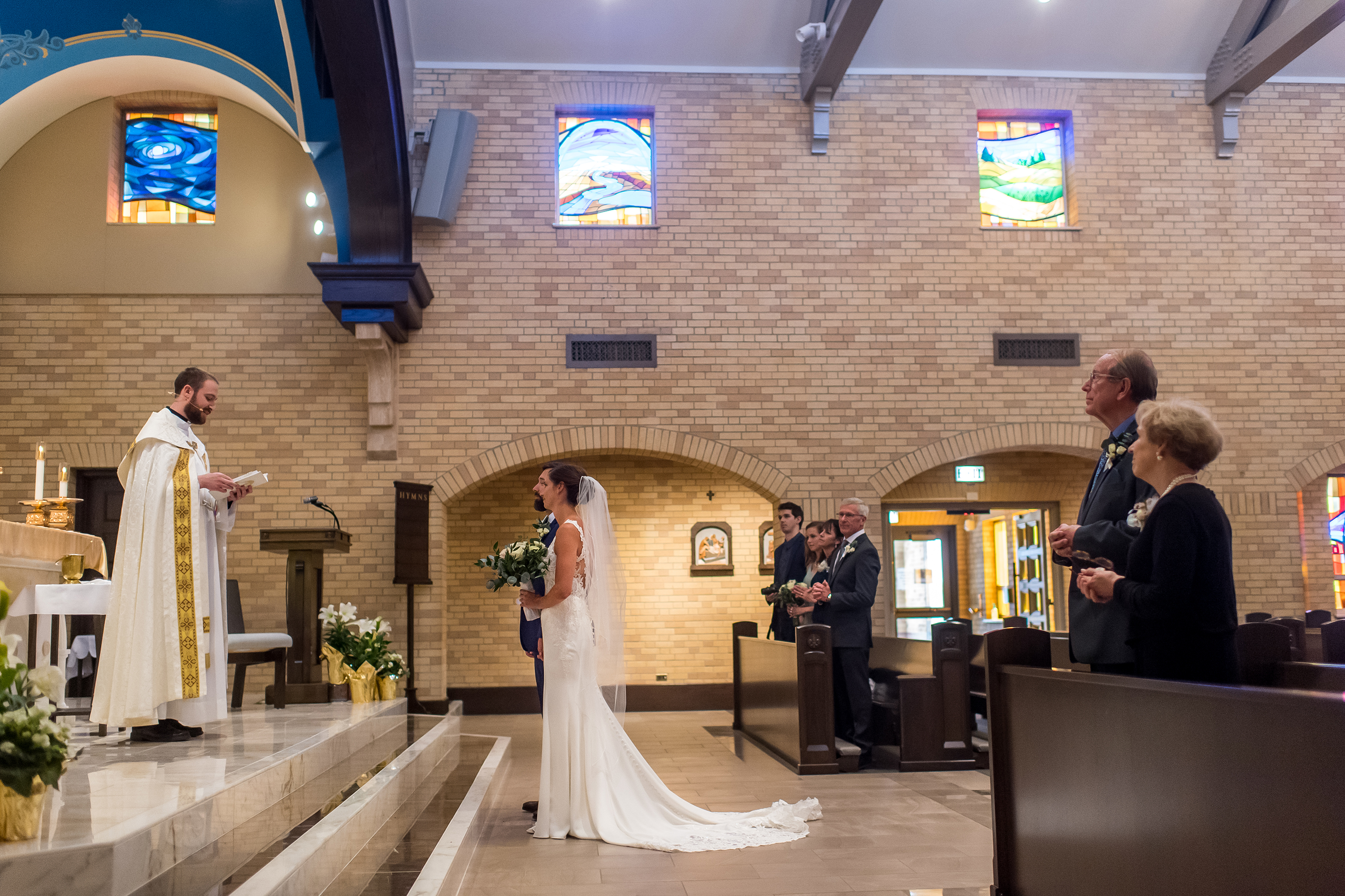 Standing at the alter for a wedding Mass at Our Lady of Lourdes Catholic Church in Denver, Colorado.