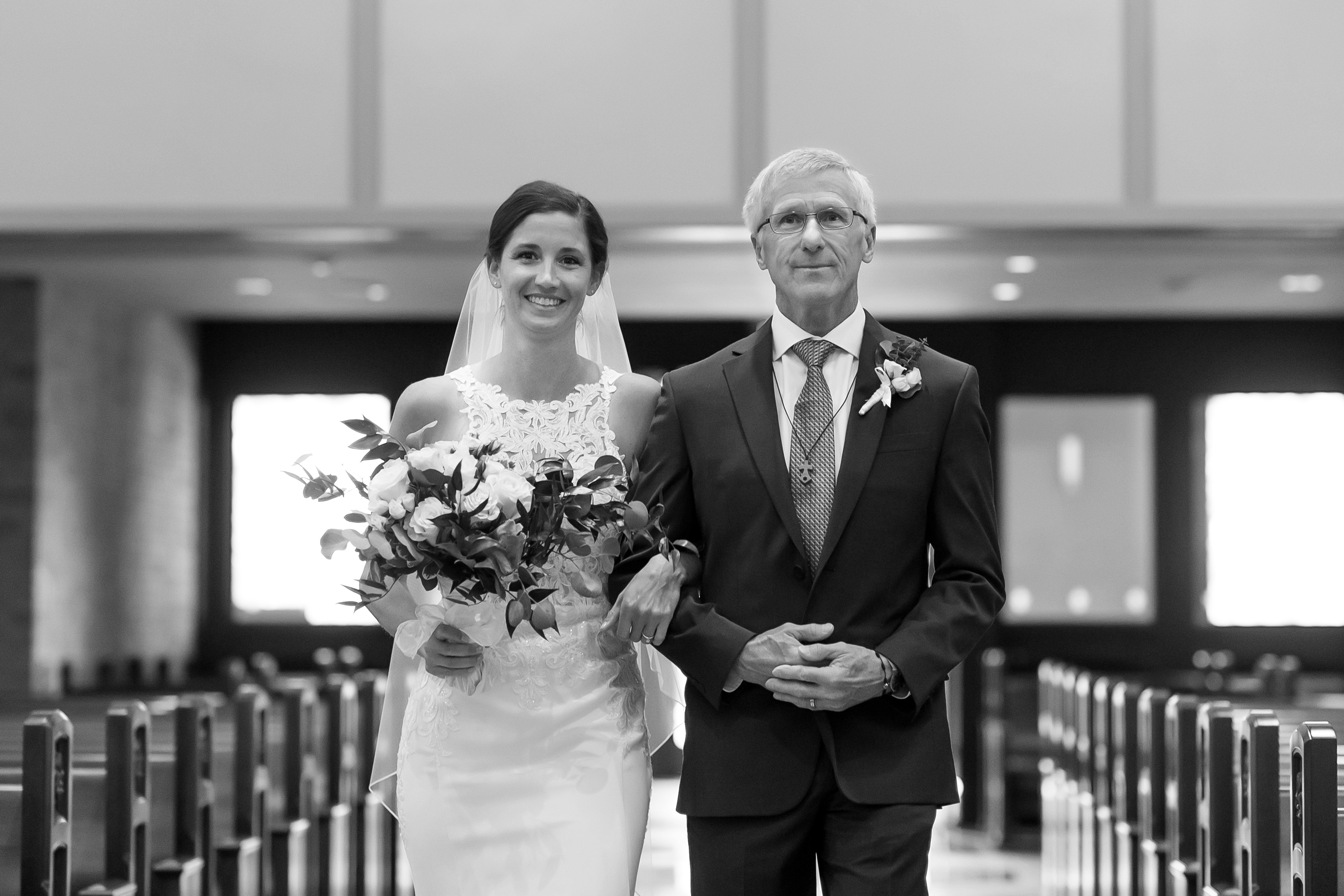 Father walks bride down the aisle at Our Lady of Lourdes Catholic Church in Denver, Colorado