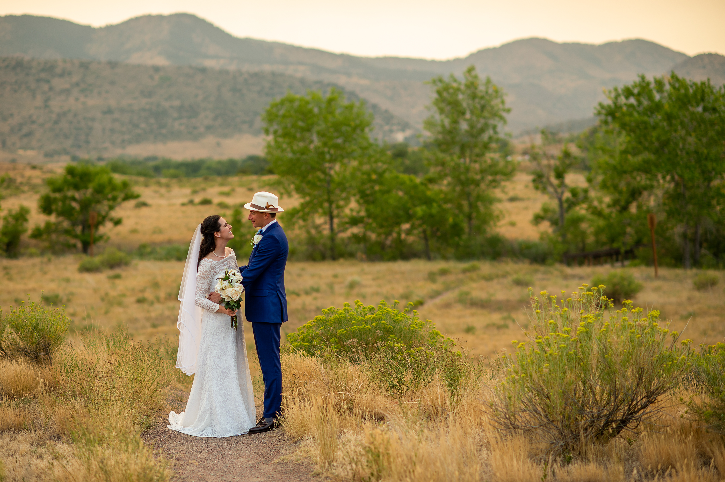 Bride and groom pose during their wedding portrait session at Bear Creek Lake Park in Lakewood, Colorado.