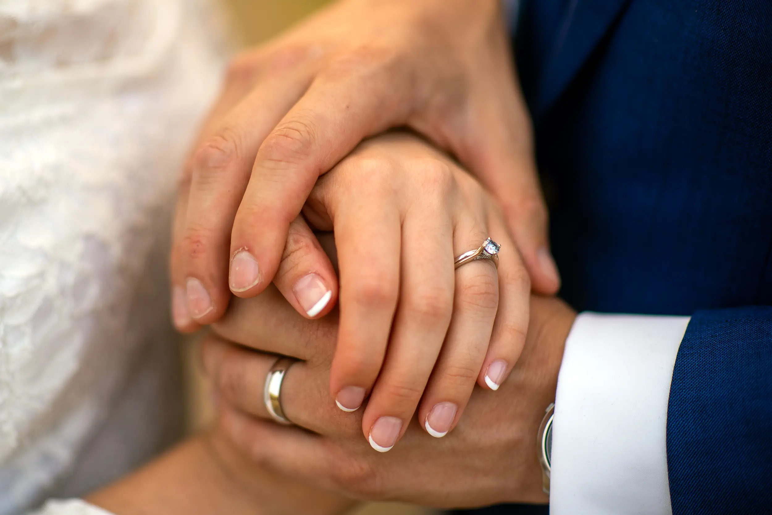 Bride and groom hold hands during their wedding portrait session at Bear Creek Lake Park in Lakewood, Colorado.