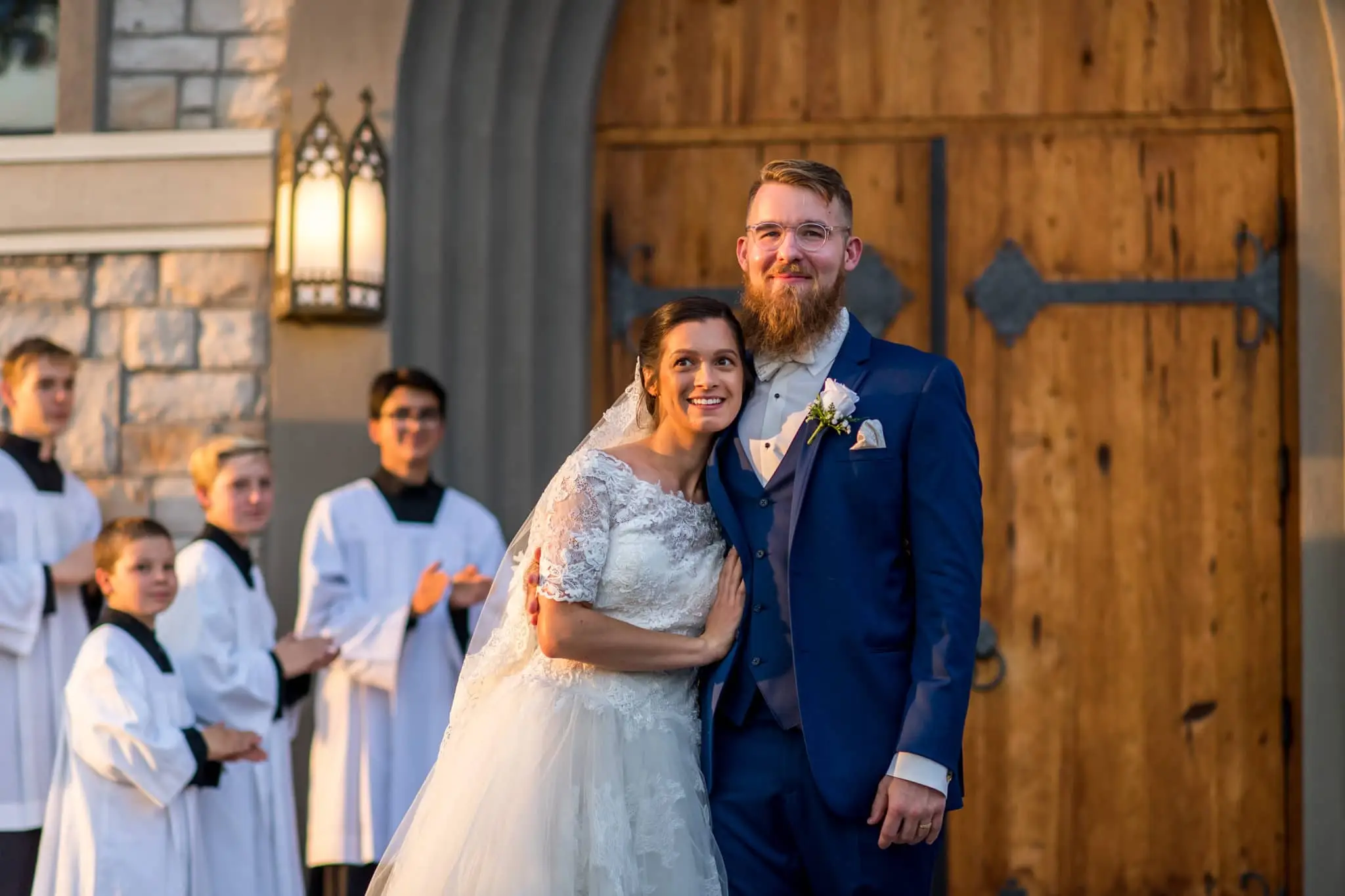 Bride and groom react outside the church after a wedding at Our Lady of Mt. Carmel in Littleton, Colorado.