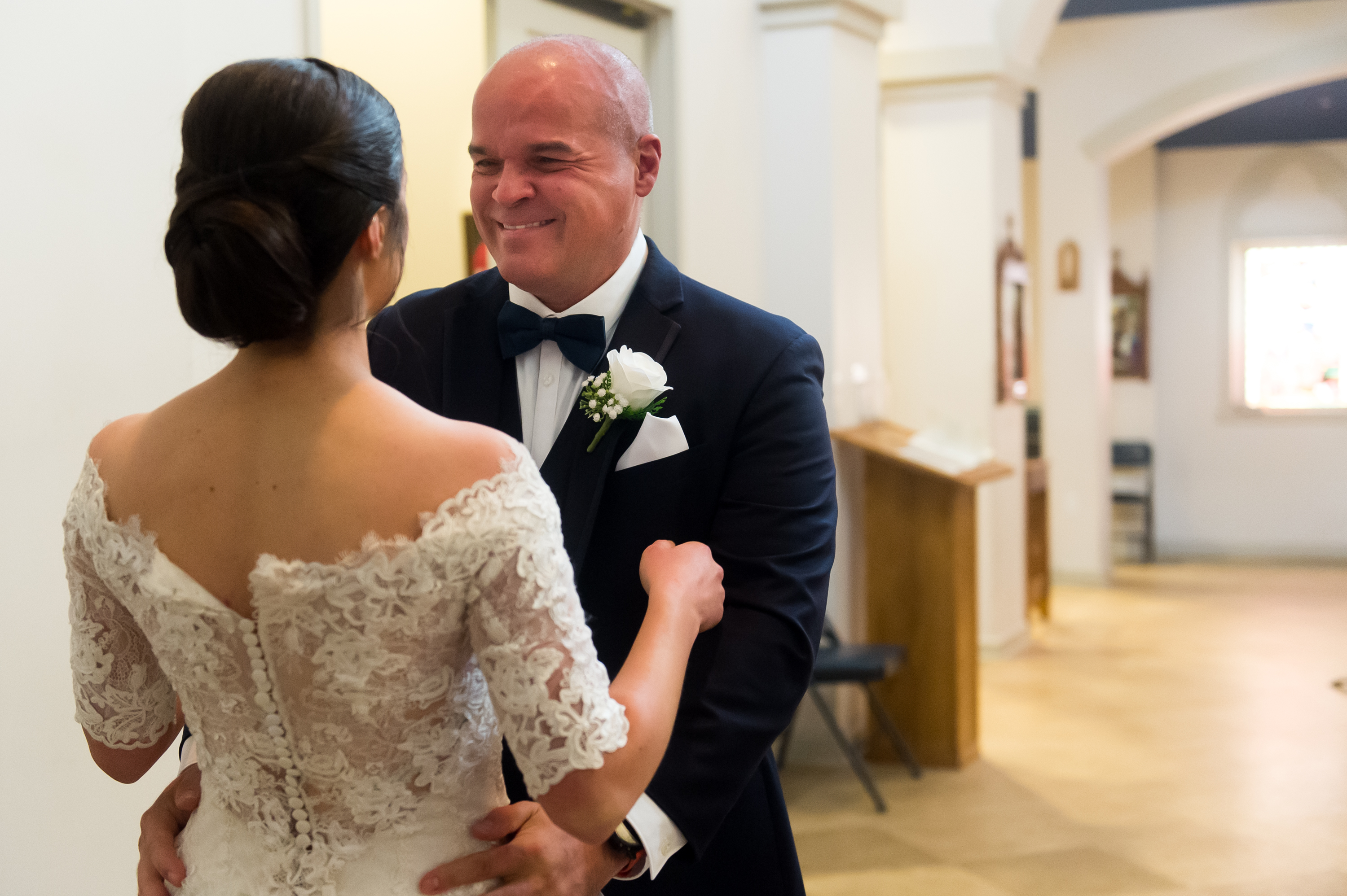 The father of the bride reacts before his daughter's wedding at Our Lady of Mt. Carmel in Littleton, Colorado.