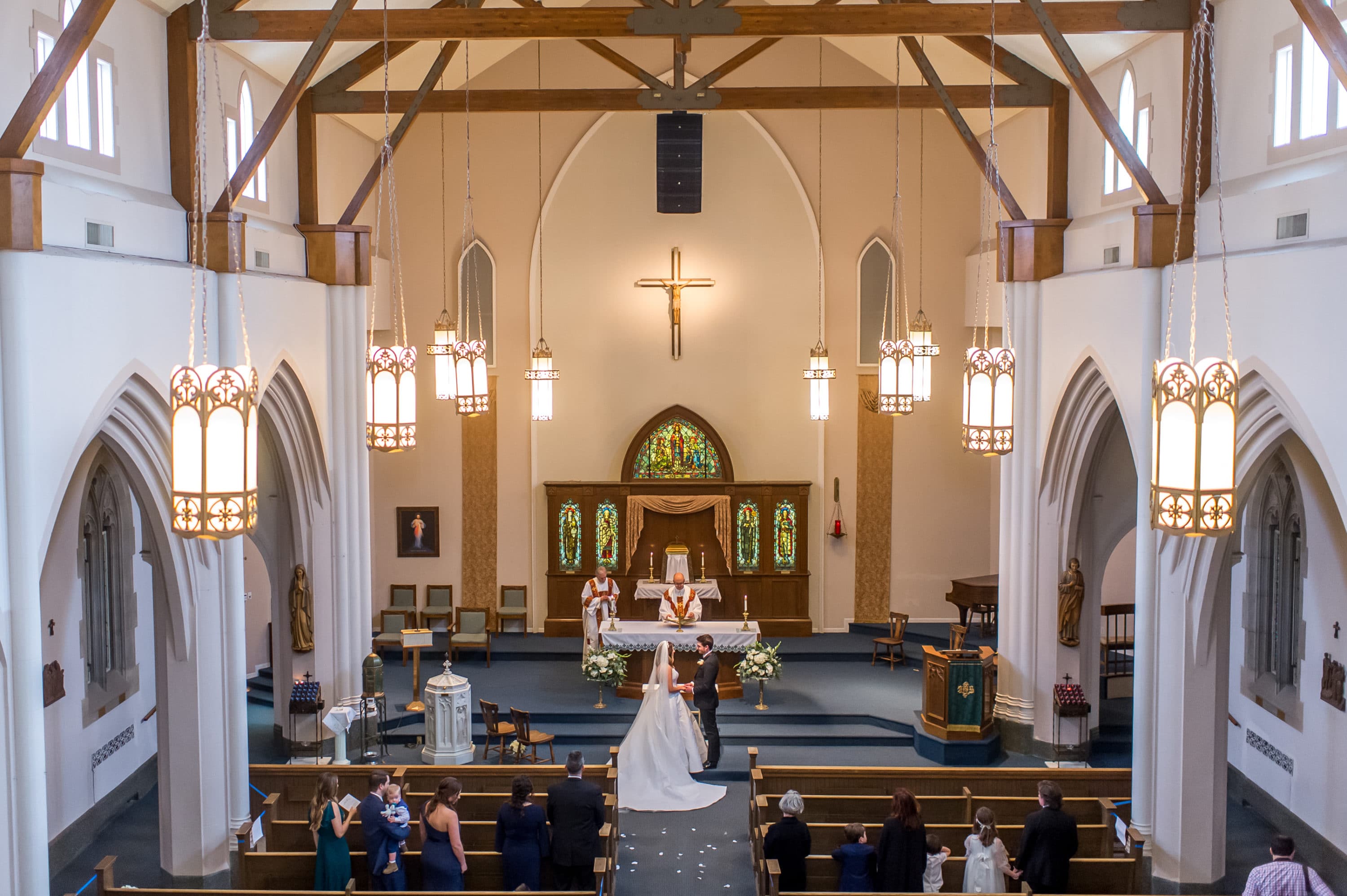 Bride and groom stand before the altar during a Blessed Sacrament Denver wedding in Colorado.