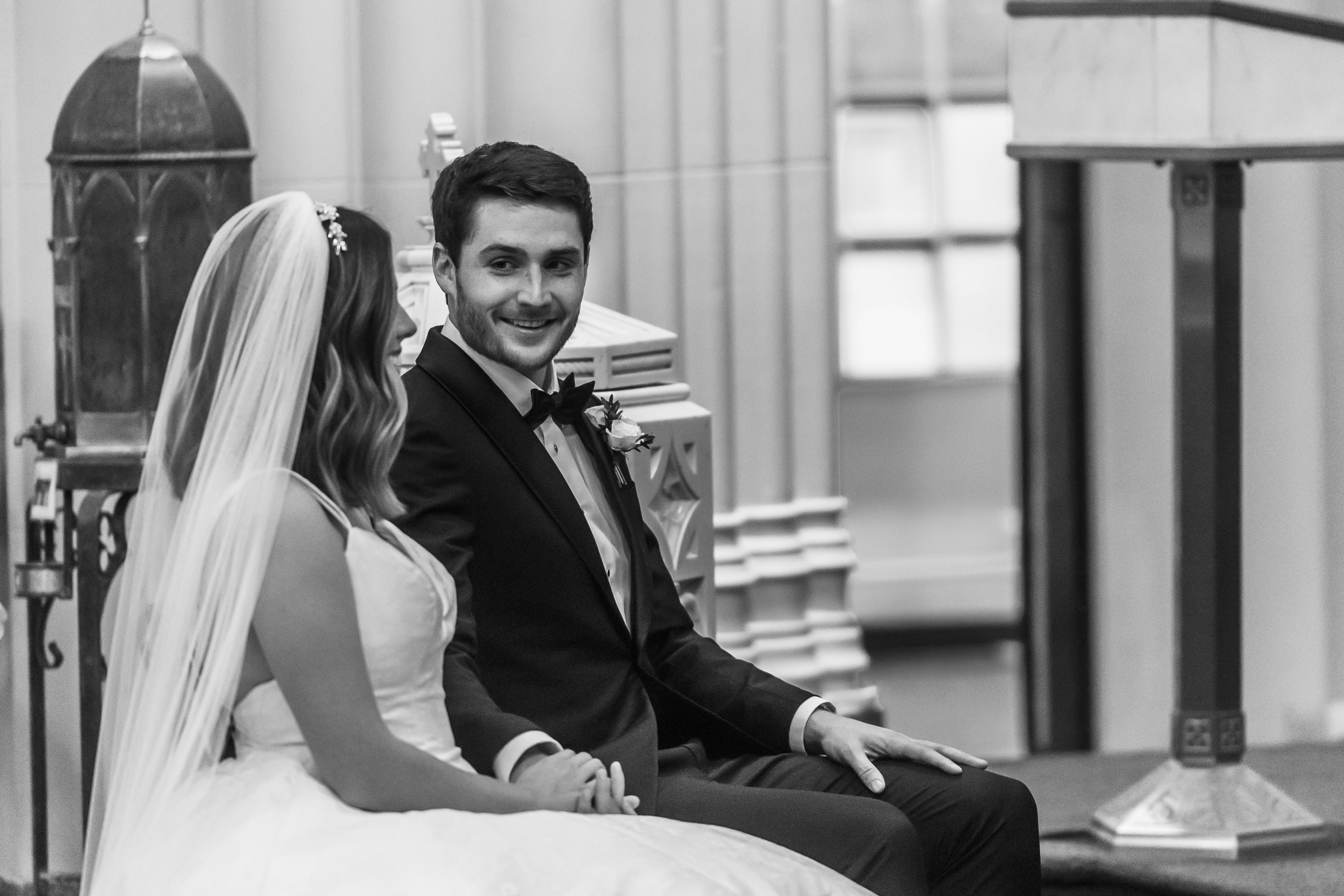 Bride and groom look at one another during a Blessed Sacrament Denver wedding ceremony in Colorado.