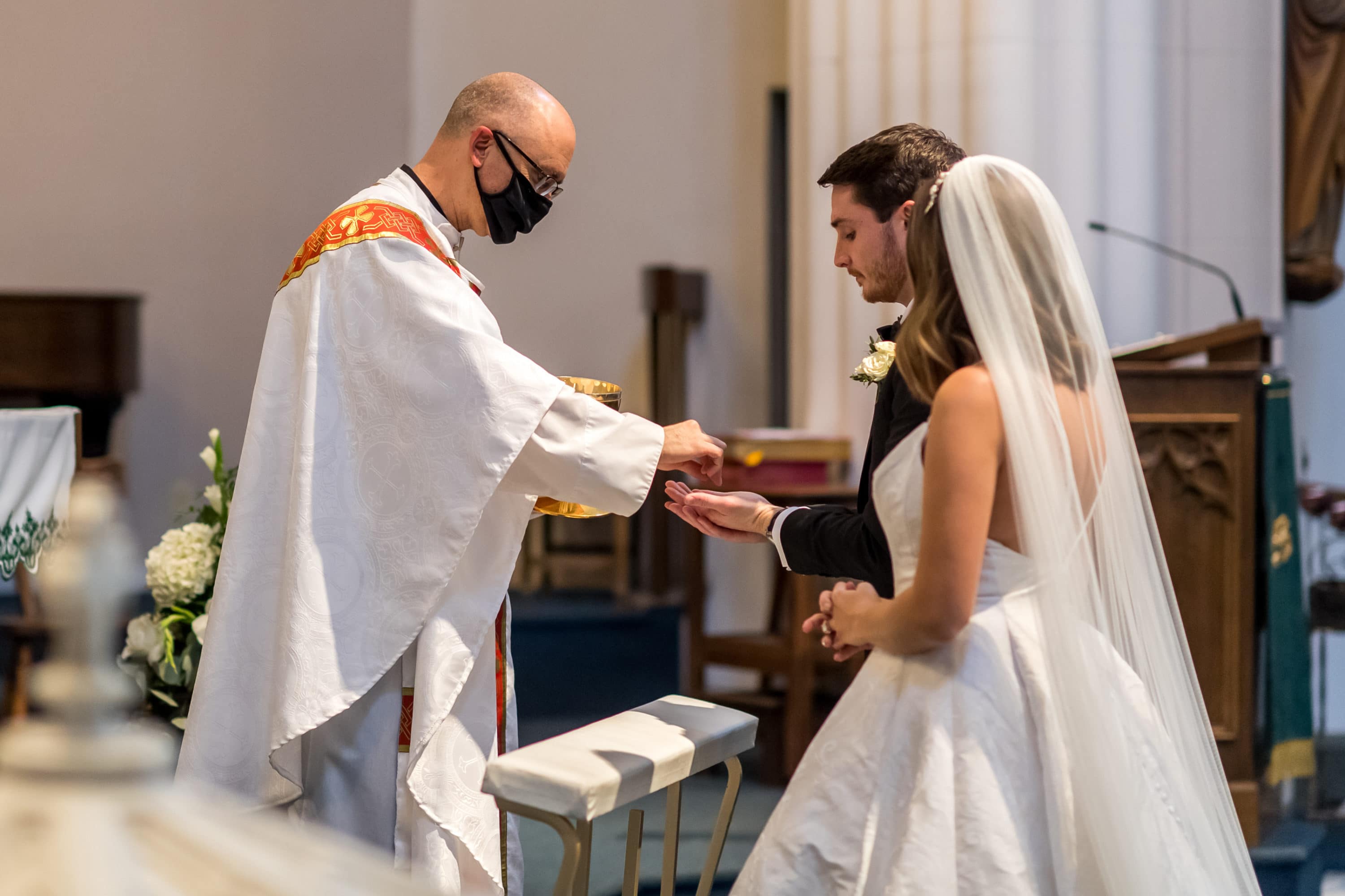 Bride and groom receive Holy Communion during a Blessed Sacrament Denver wedding.