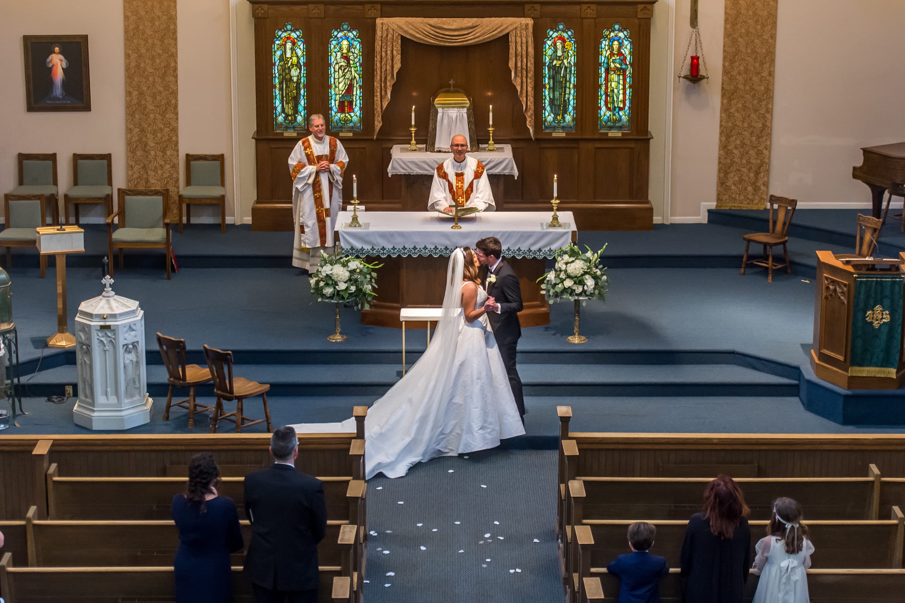 Bride and Groom kiss during a Blessed Sacrament Denver wedding ceremony.