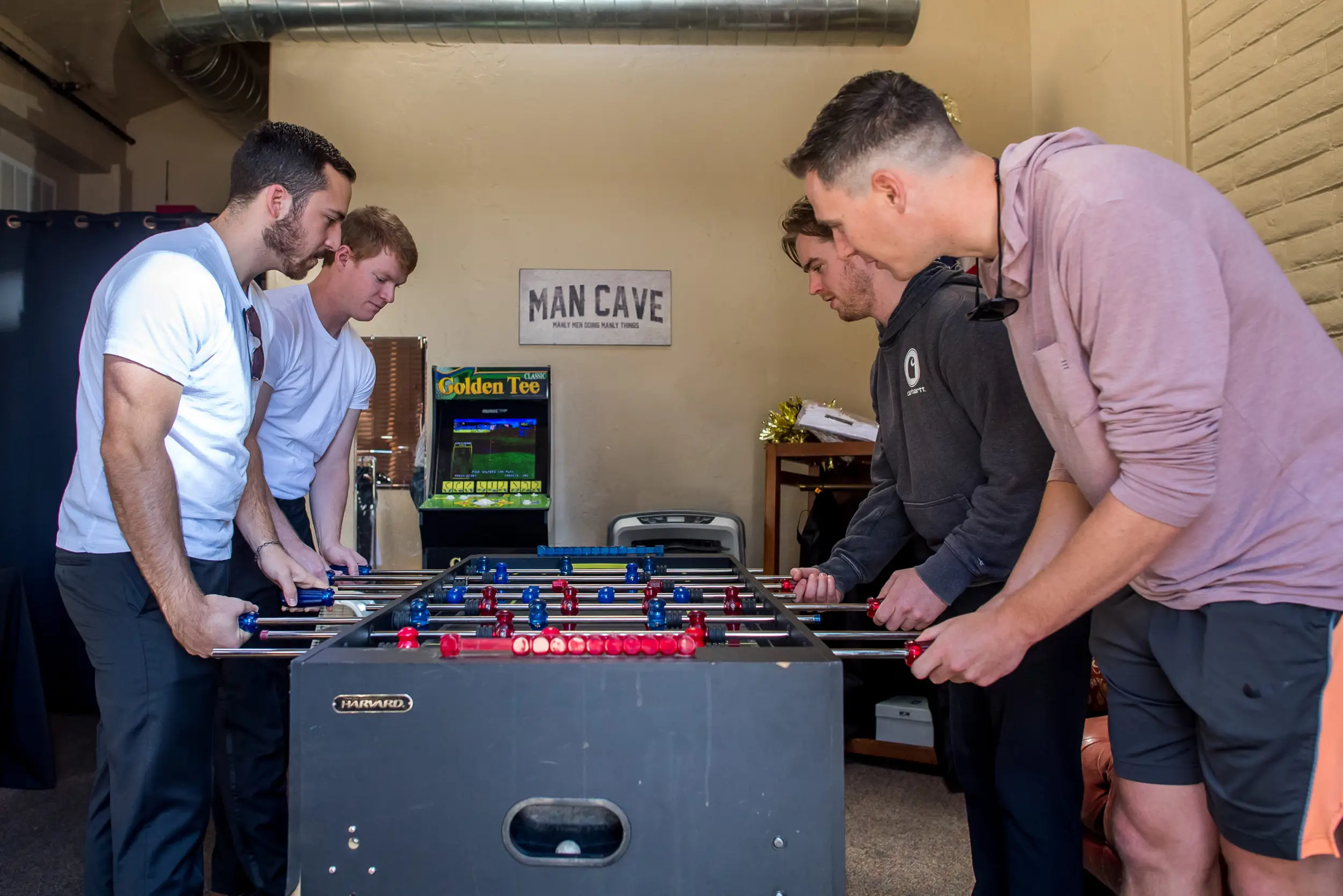 Groomsmen play before a wedding at Baldoria on the Water in Lakewood, Colorado.