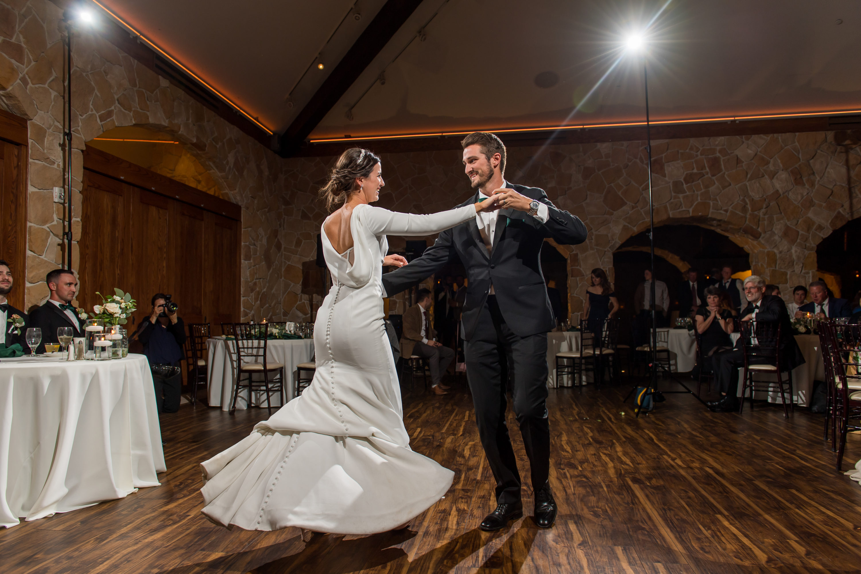 Bride and brother dance at Baldoria on the Water wedding venue in Lakewood, Colorado.