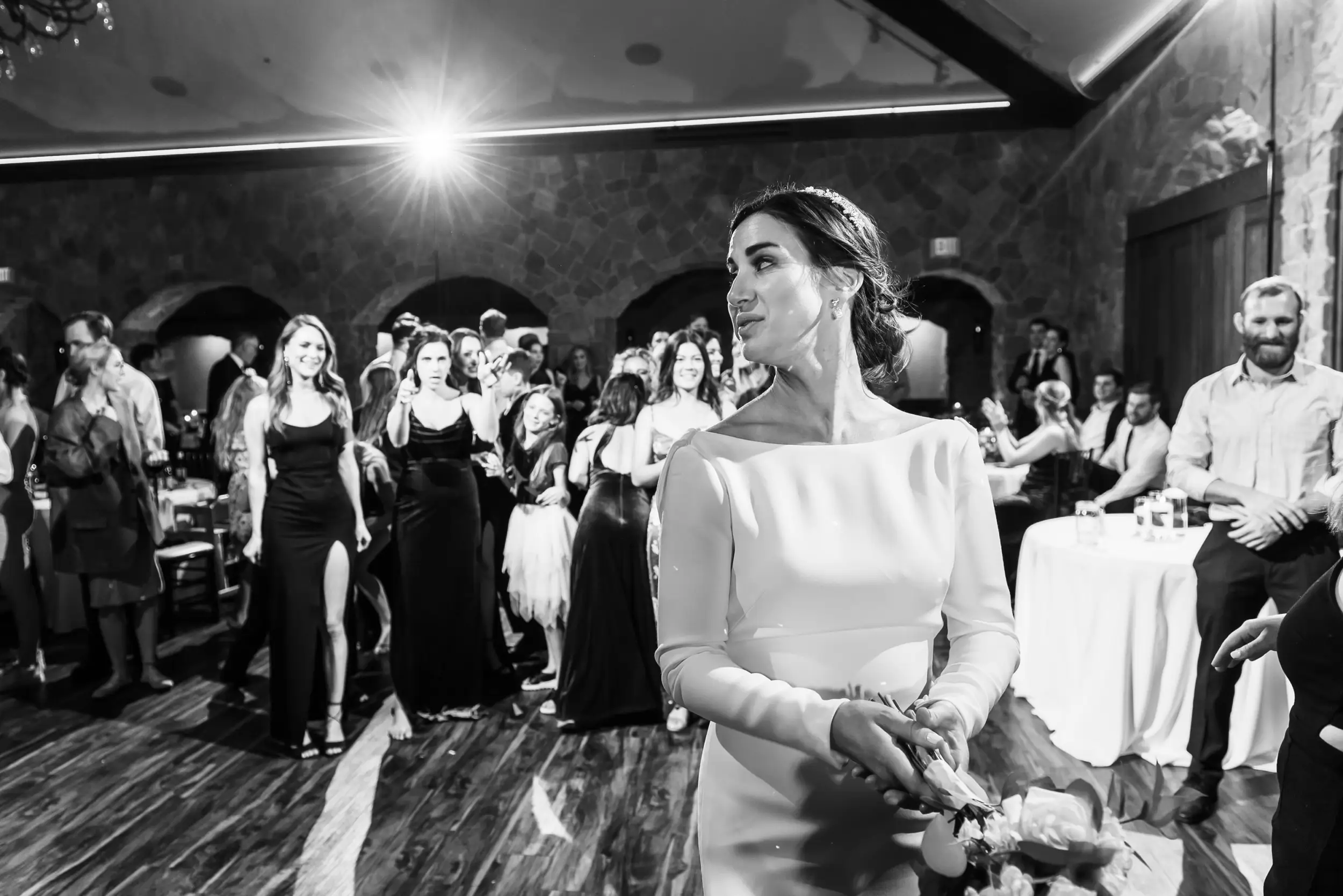 Bride throws the bouquet at Baldoria on the Water wedding venue in Lakewood, Colorado.