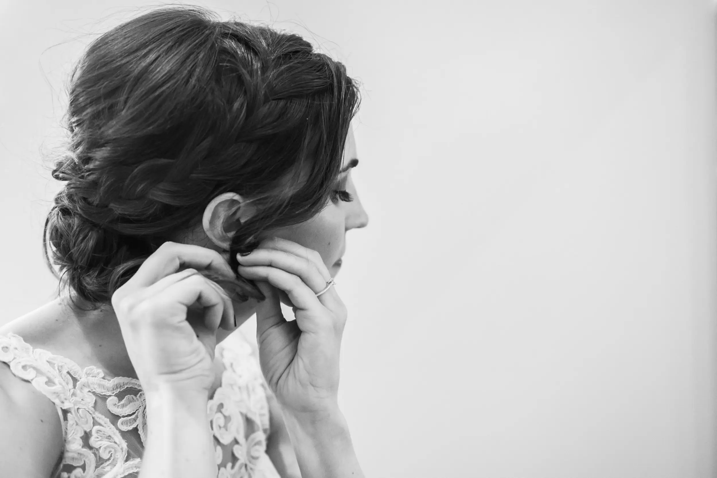 The bride puts on her earrings before her Cathedral Basilica of the Immaculate Conception wedding in Denver, Colorado.