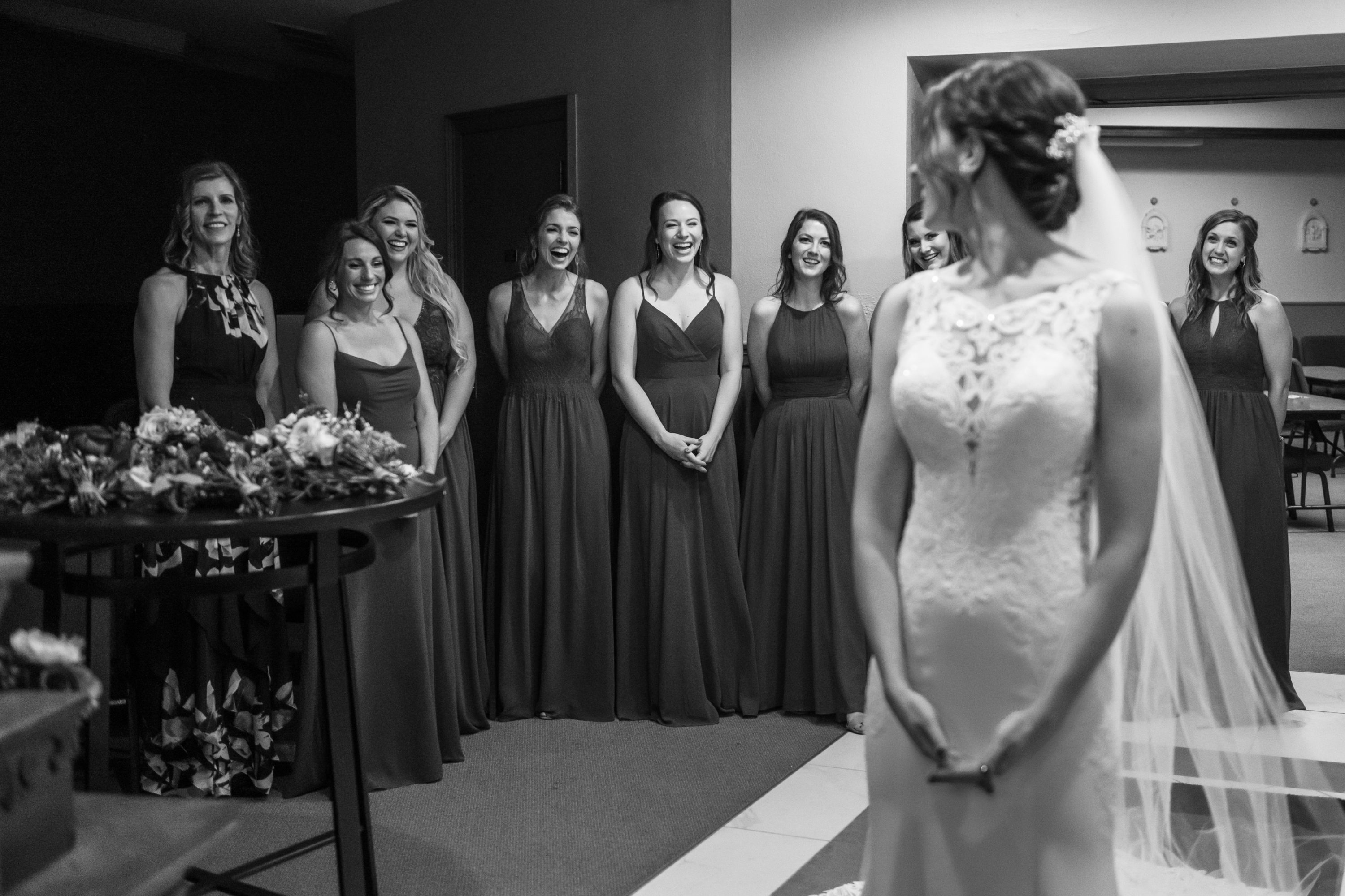 The bridesmaids look at the bride before her Cathedral Basilica of the Immaculate Conception wedding in Denver, Colorado.