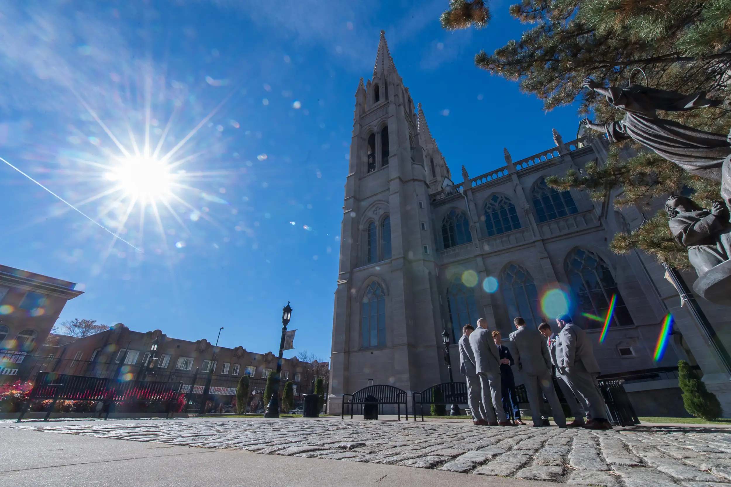 Groomsmen pray over the groom before his Cathedral Basilica of the Immaculate Conception wedding in Denver, Colorado.