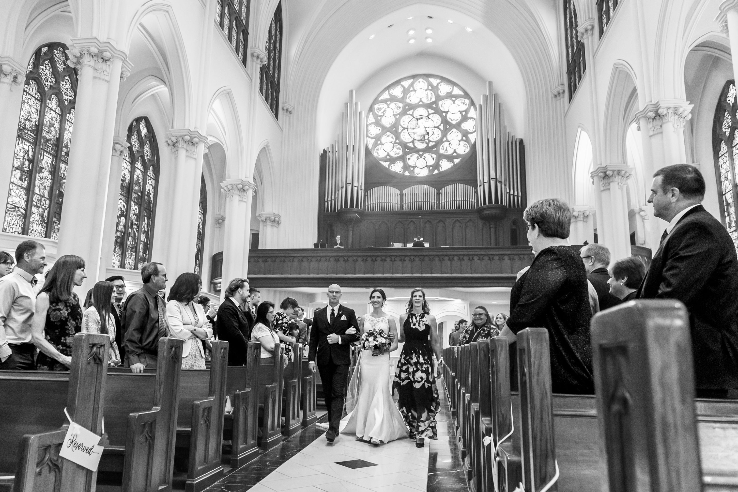 The bride processes in during her Cathedral Basilica of the Immaculate Conception wedding in Denver, Colorado.