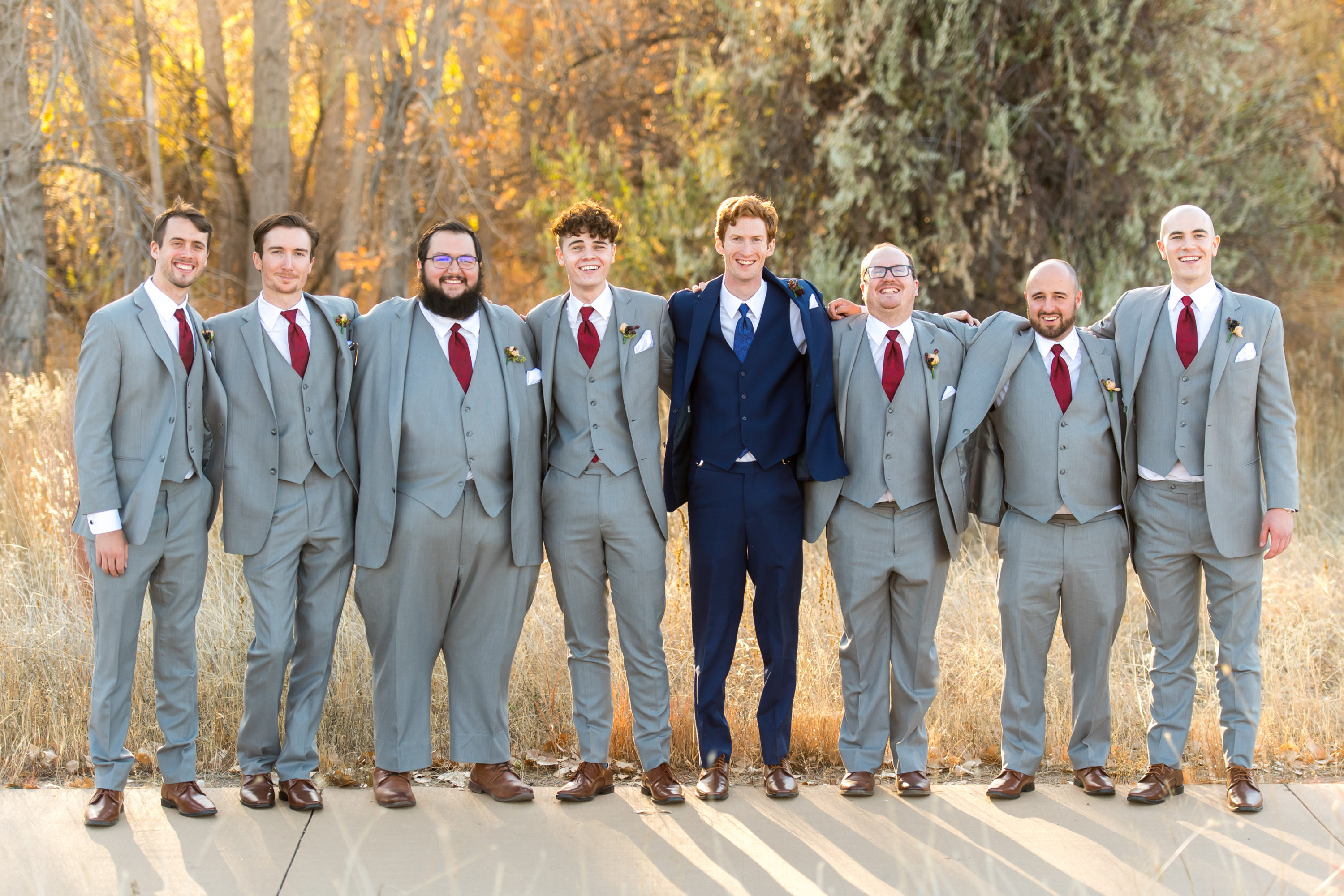 Groom poses with his groomsmen at Cherry Creek State Park in Aurora, Colorado.