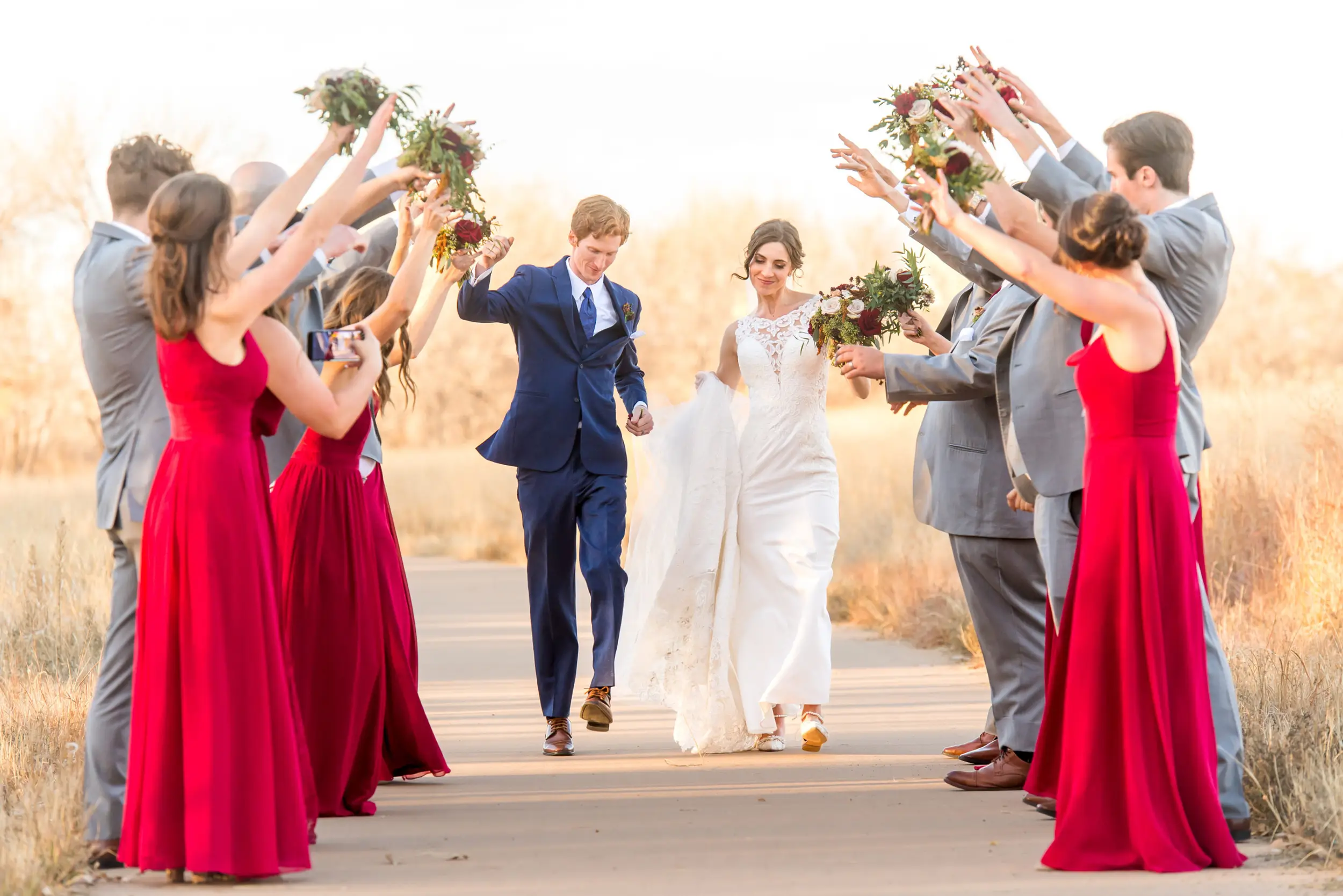 Bride and groom walk through the bridal party at Cherry Creek State Park in Aurora, Colorado.