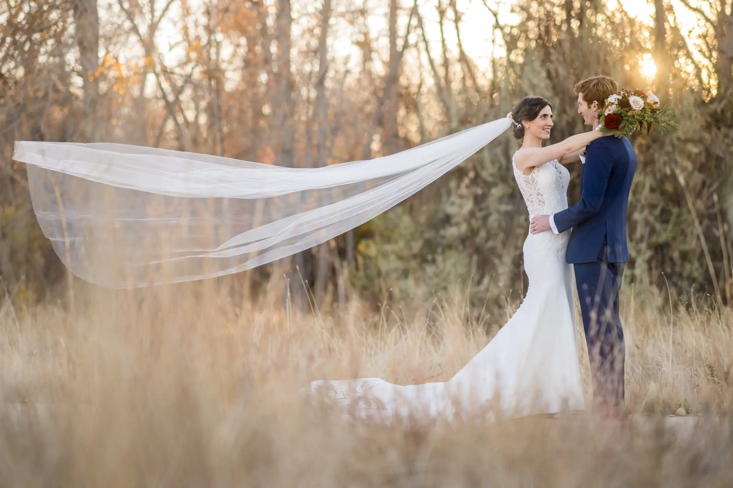 Bride and groom pose for photos at Cherry Creek State Park in Aurora, Colorado.