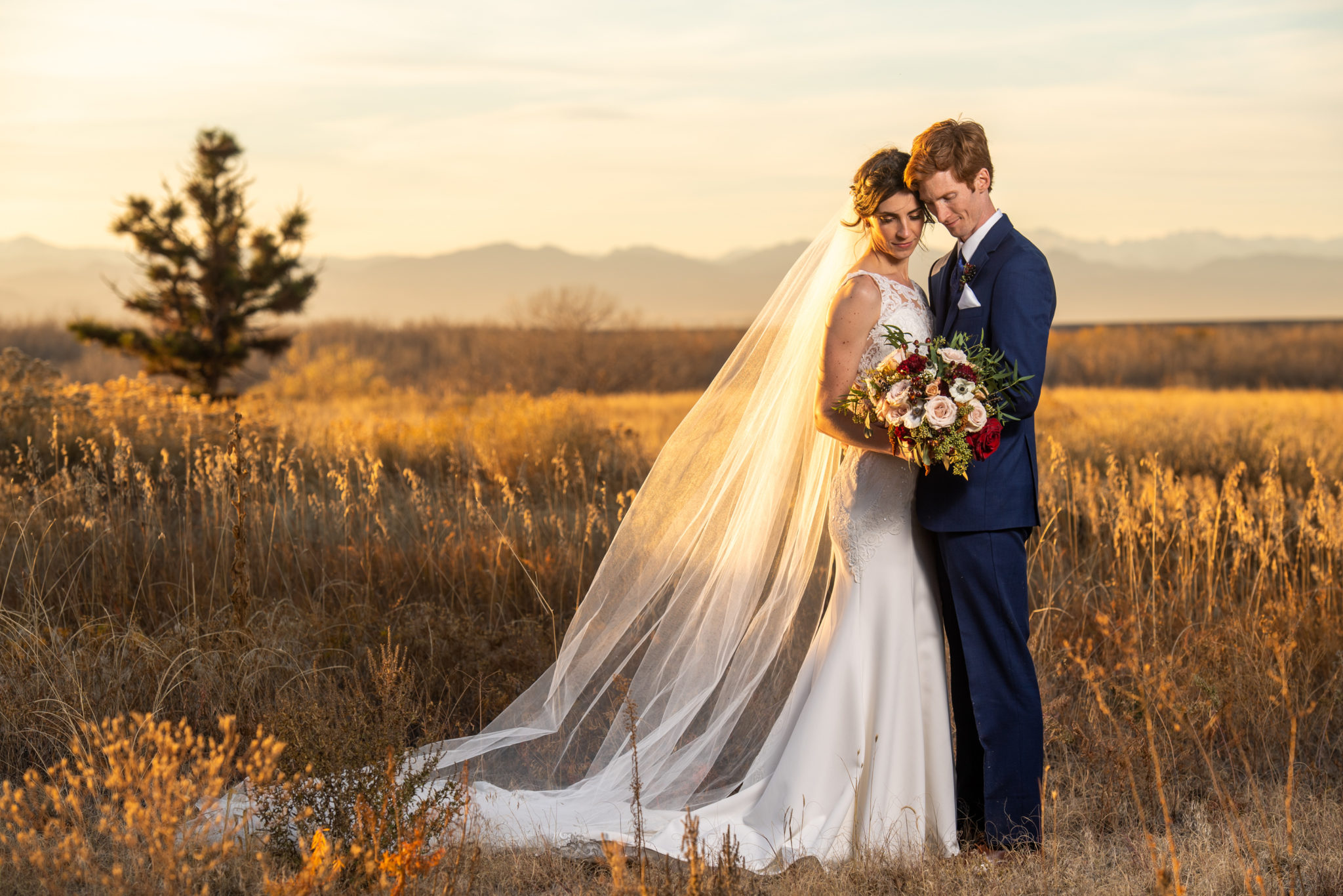 Bride and groom pose for photos at Cherry Creek State Park in Aurora, Colorado.
