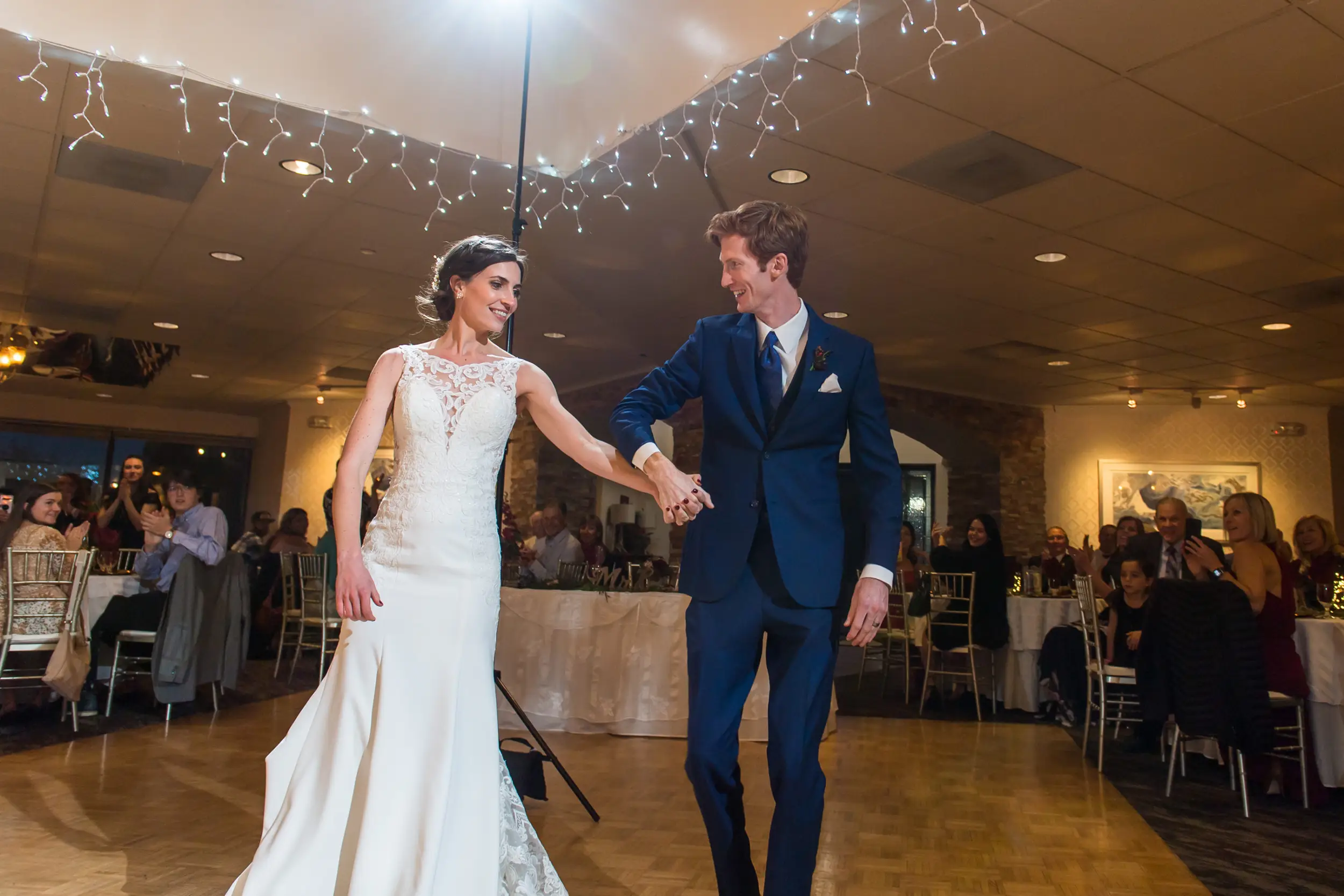 Bride and groom are introduced during a wedding reception at the Franciscan Event Center in Centennial, Colorado.