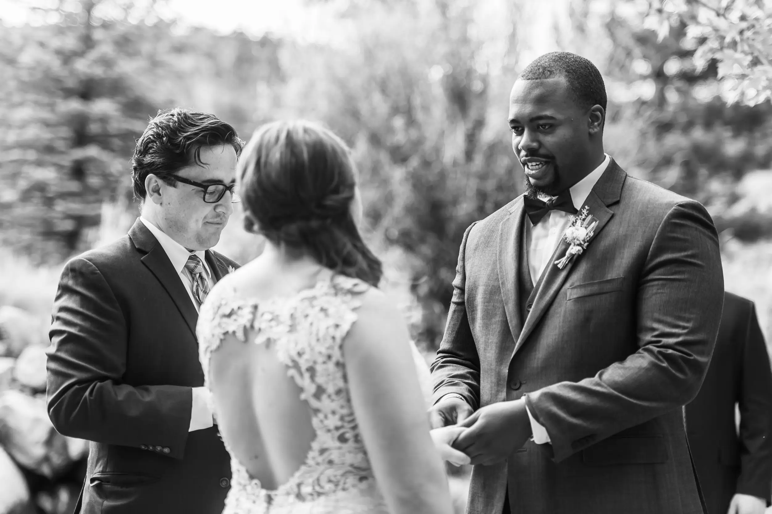 Groom puts the ring on the bride's finger during a Greenbriar Inn wedding in Boulder, Colorado.