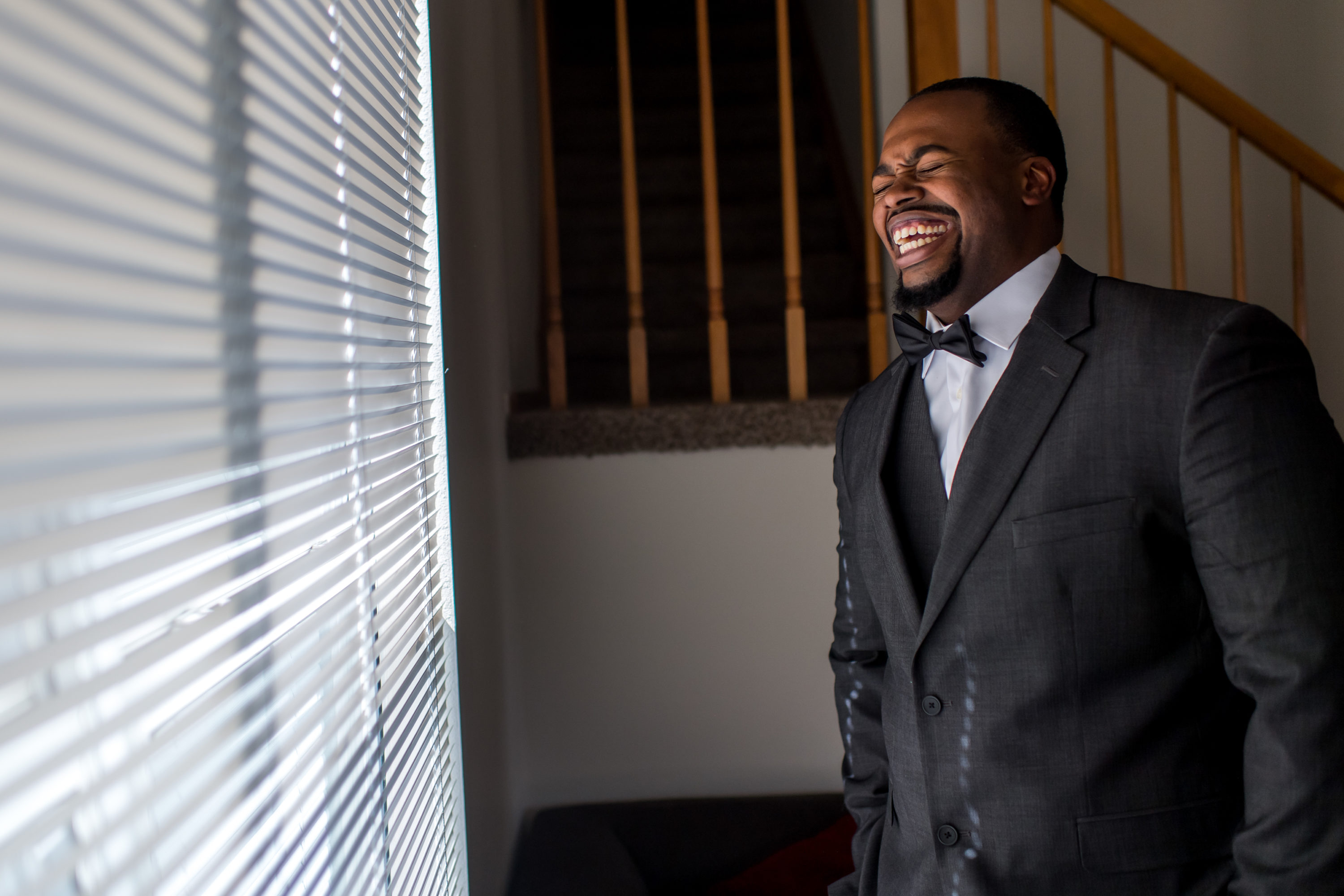 The groom laughs and smiles before a Greenbriar Inn wedding in Boulder, Colorado.