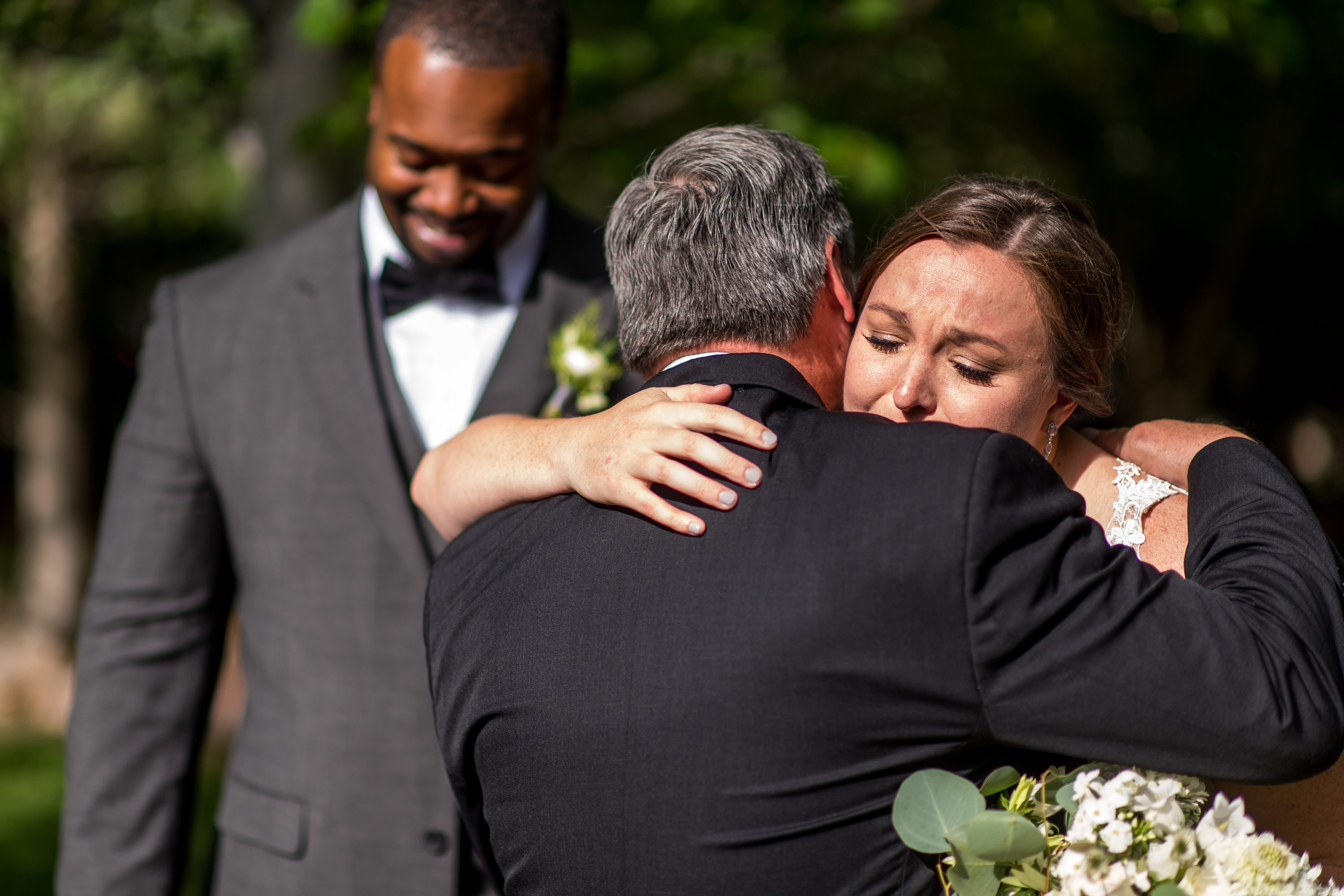 The bride hugs her father during a Greenbriar Inn wedding in Boulder, Colorado.