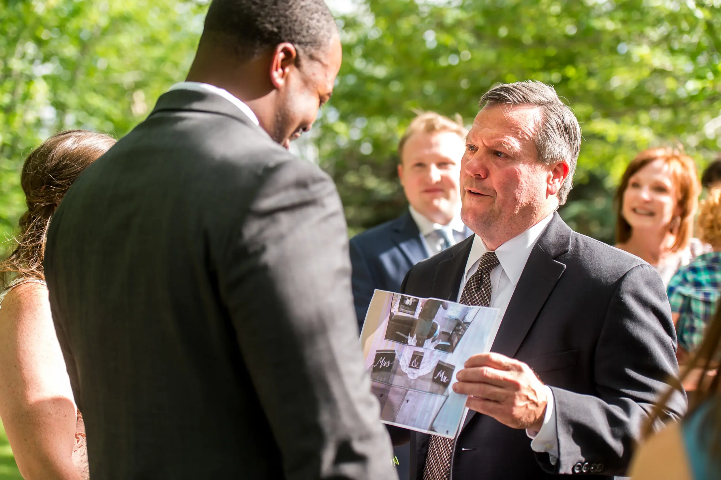 The father presents something to the groom after a Greenbriar Inn wedding in Boulder, Colorado.