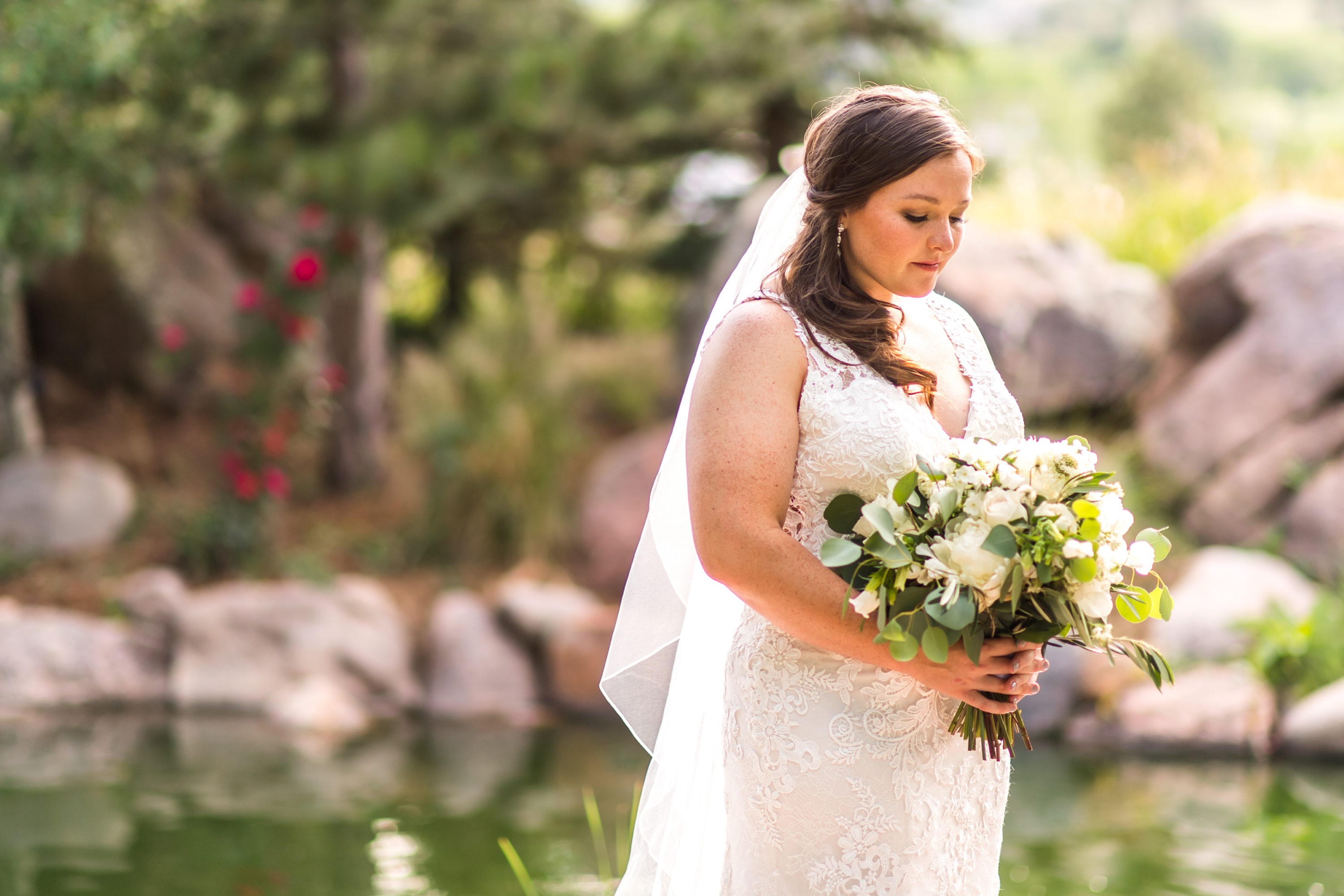 The bride looks down at her bouquet during a Greenbriar Inn wedding in Boulder, Colorado.