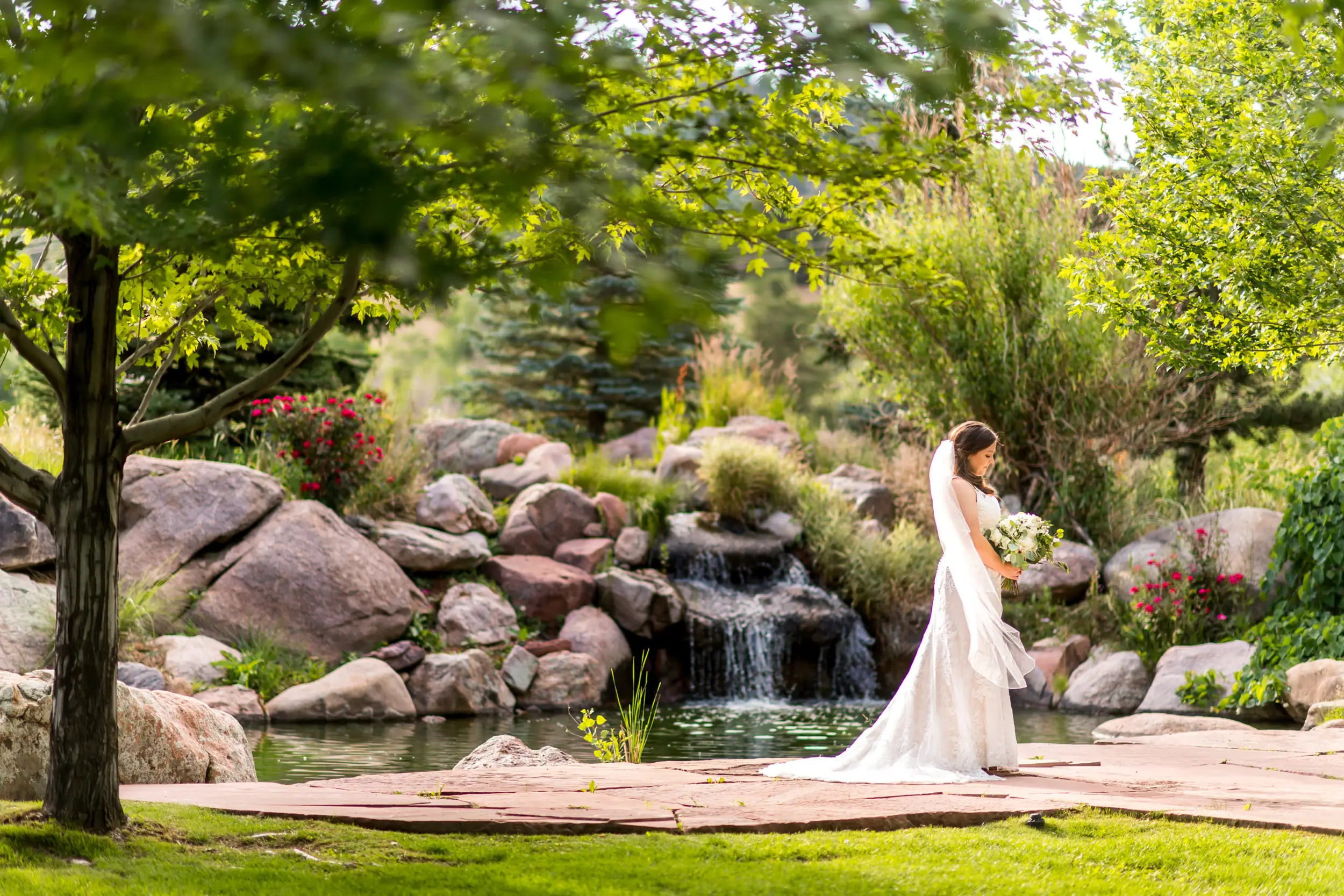 The bride looks down at her bouquet during a Greenbriar Inn wedding in Boulder, Colorado.
