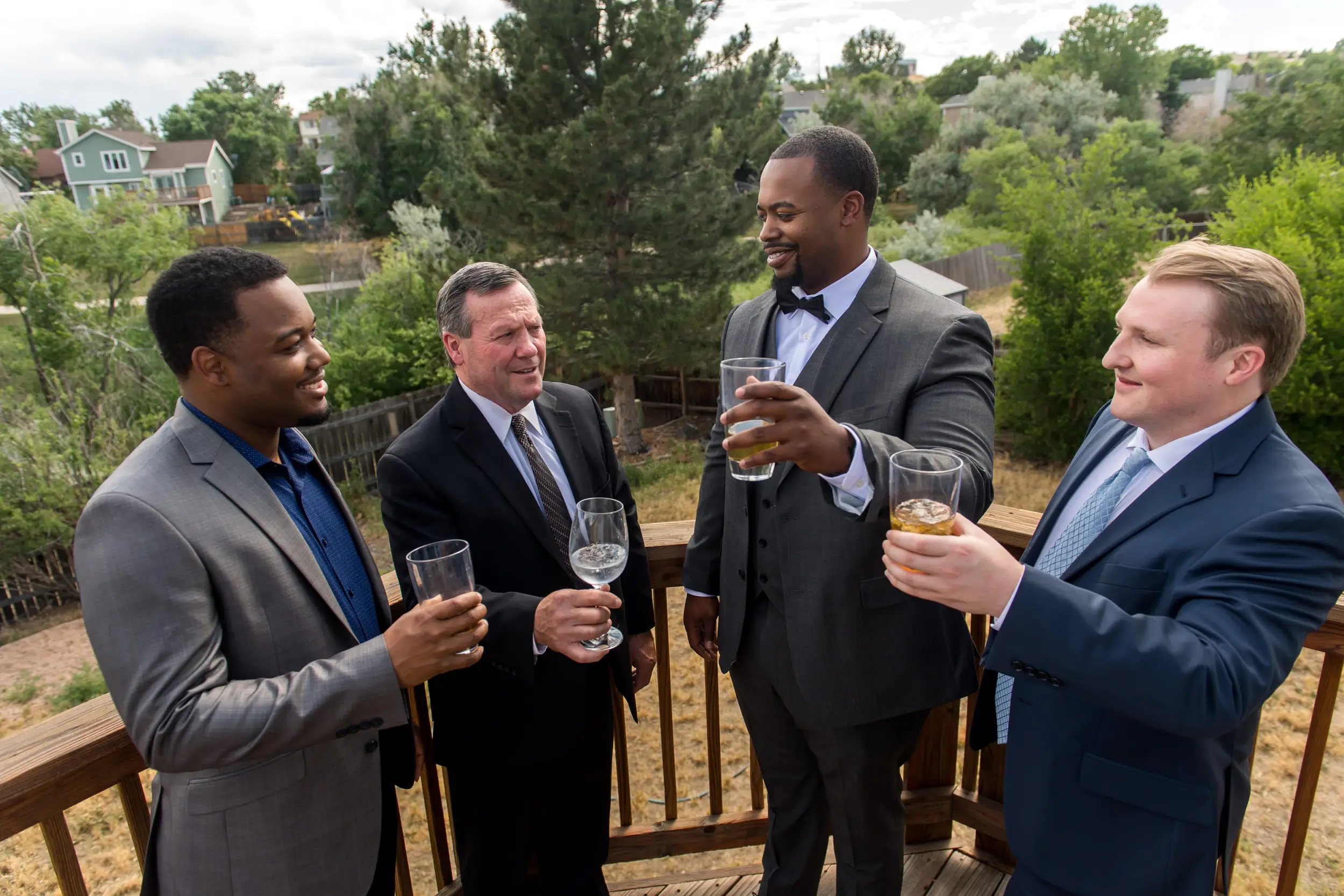 The groom, father of the bride and groomsmen toast before a Greenbriar Inn wedding in Boulder, Colorado.