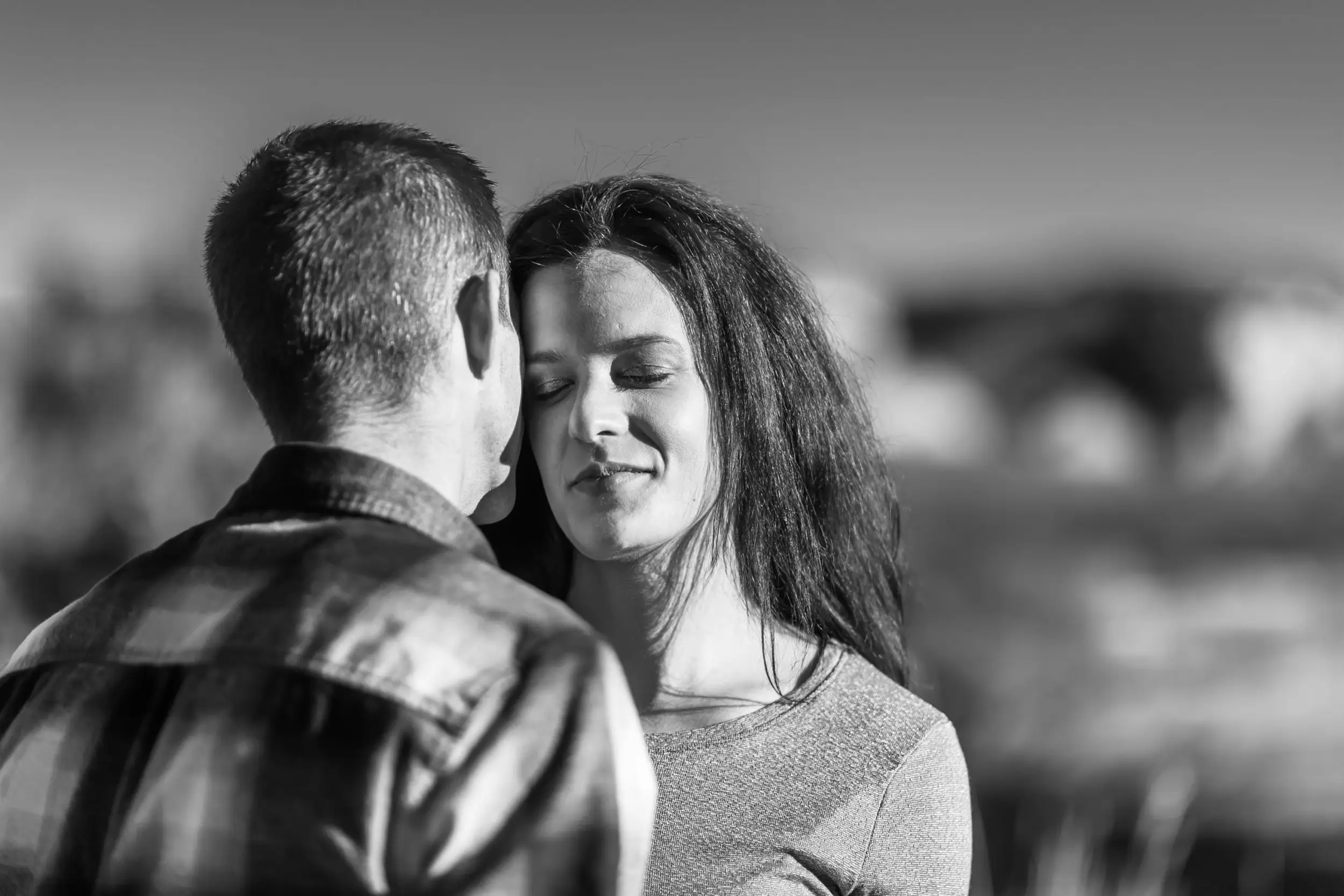 Victoria and Justin embrace in Roxborough State Park Littleton for their engagement session.