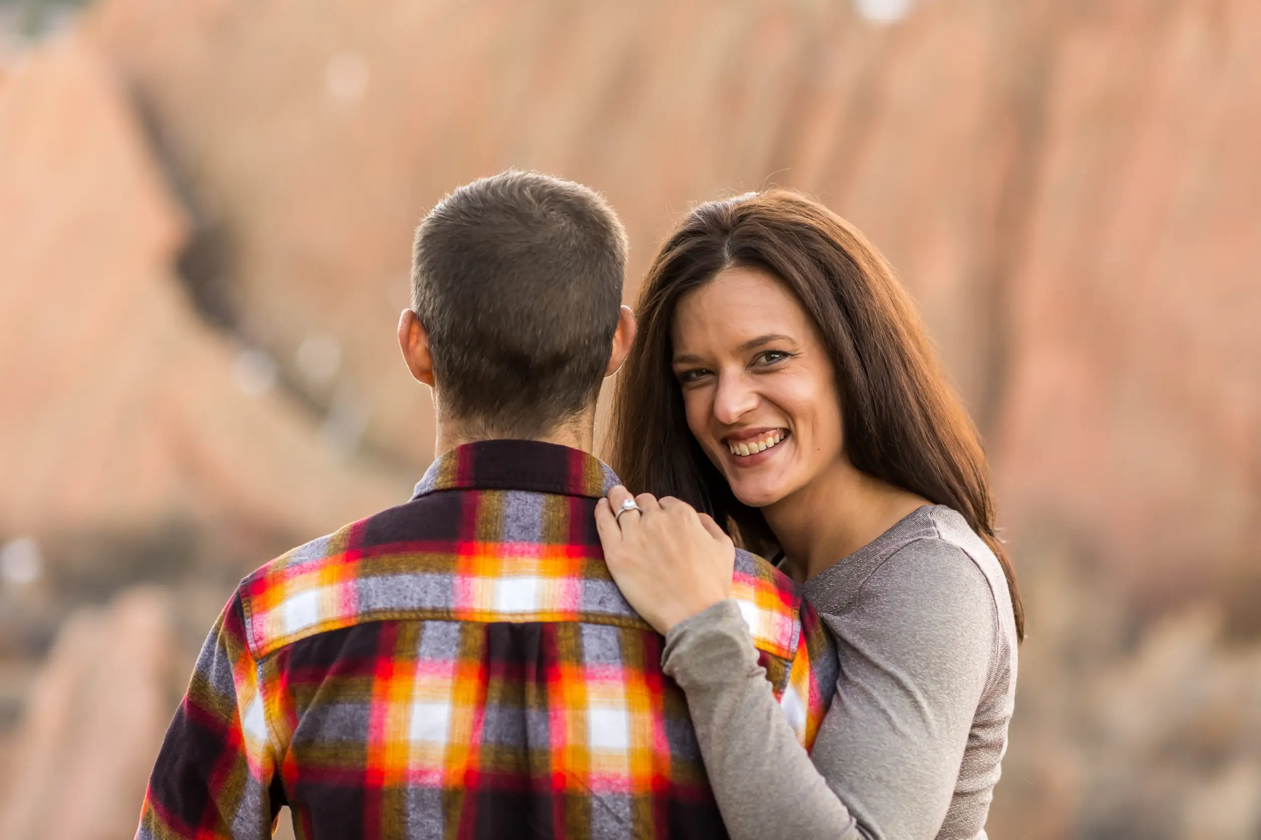 Victoria and Justin embrace in Roxborough State Park Littleton for their engagement session.