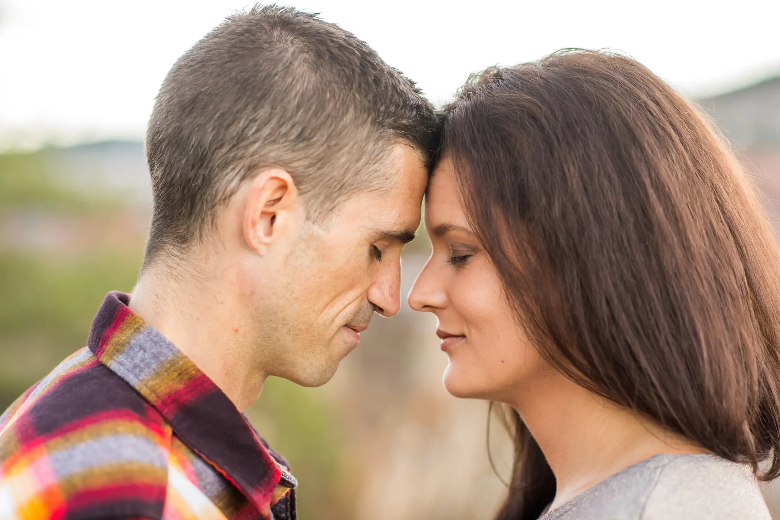 Victoria and Justin embrace in Roxborough State Park Littleton for their engagement session.