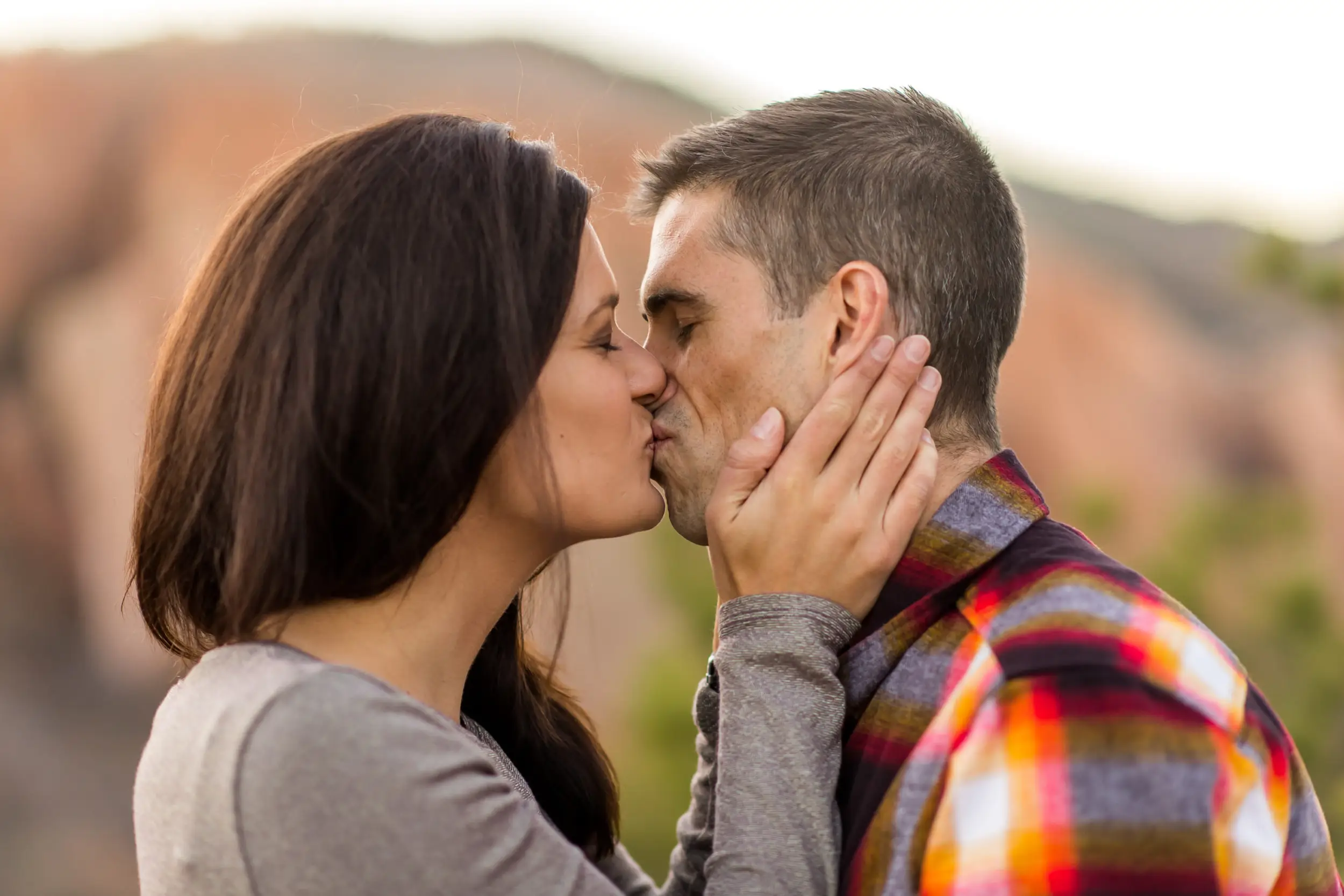 Victoria and Justin embrace in Roxborough State Park Littleton for their engagement session.