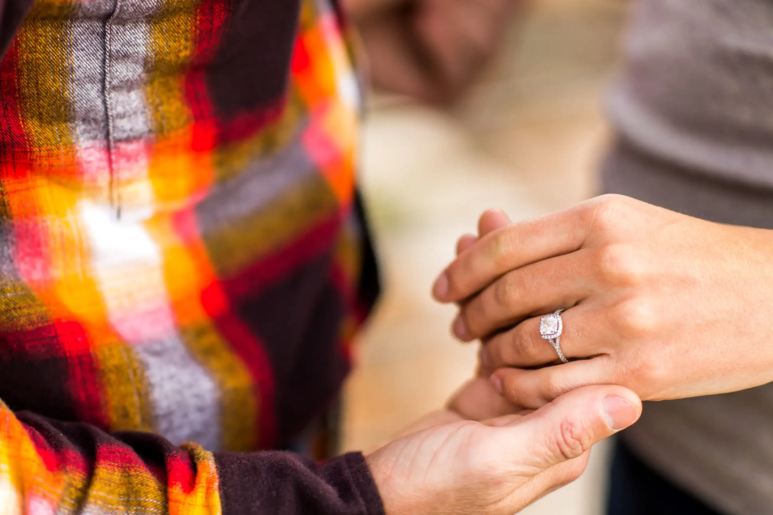 Victoria and Justin embrace in Roxborough State Park Littleton for their engagement session.