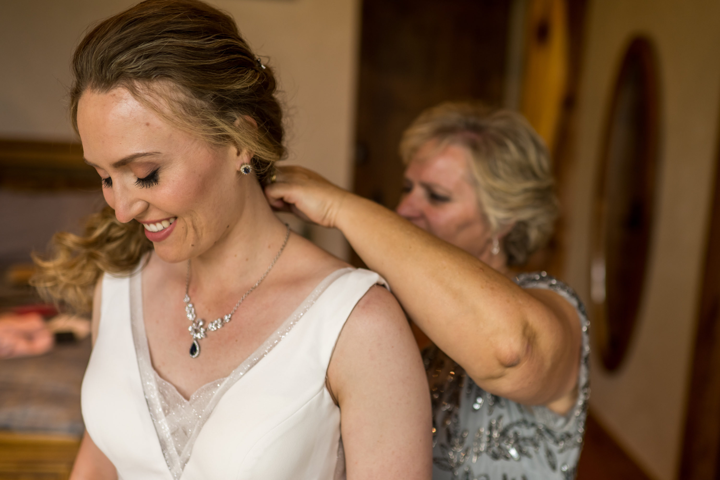 The bride's mother adjusts her dress before her Telluride, Colorado, wedding.