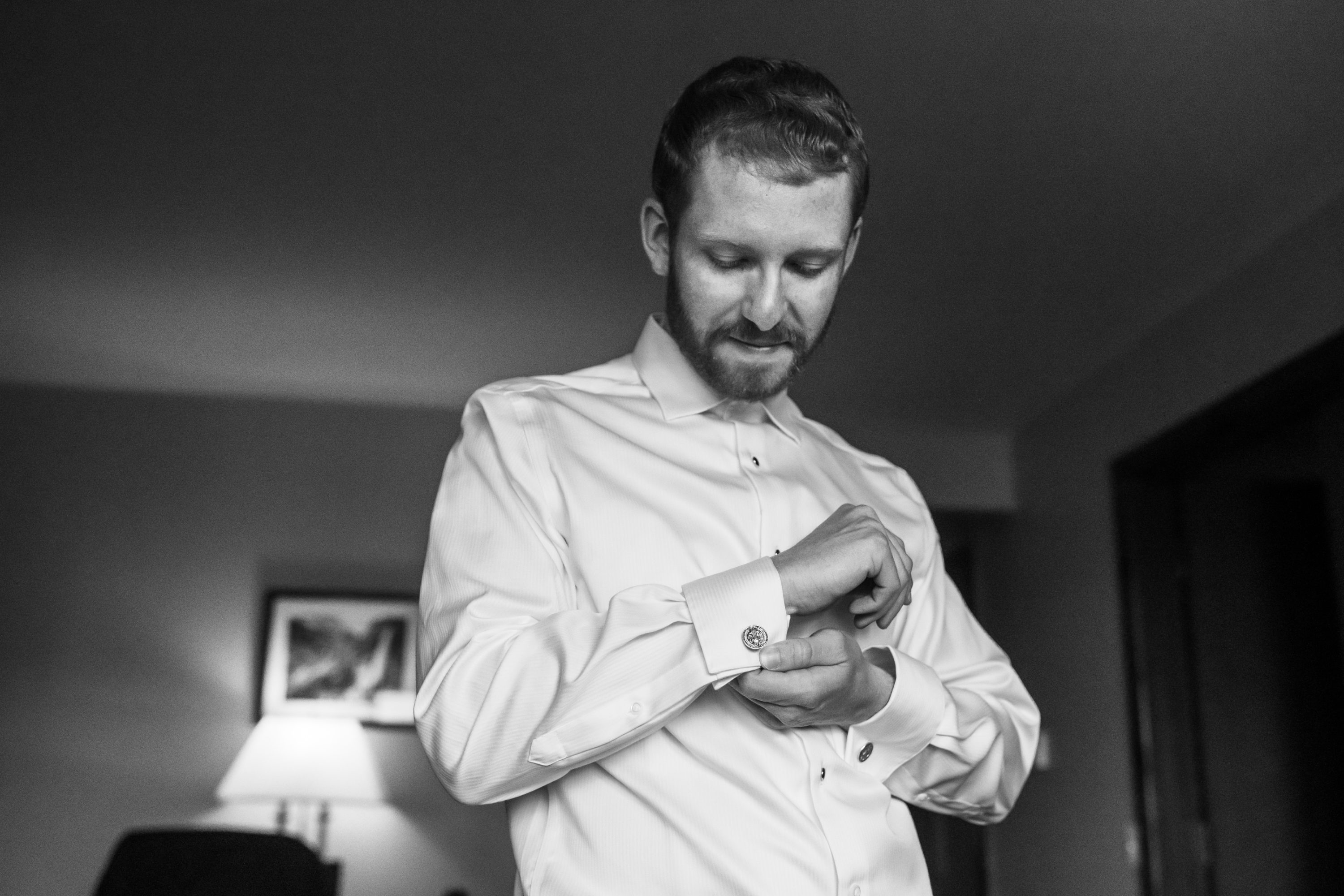 The groom puts in cufflinks before his wedding in Telluride, Colorado.