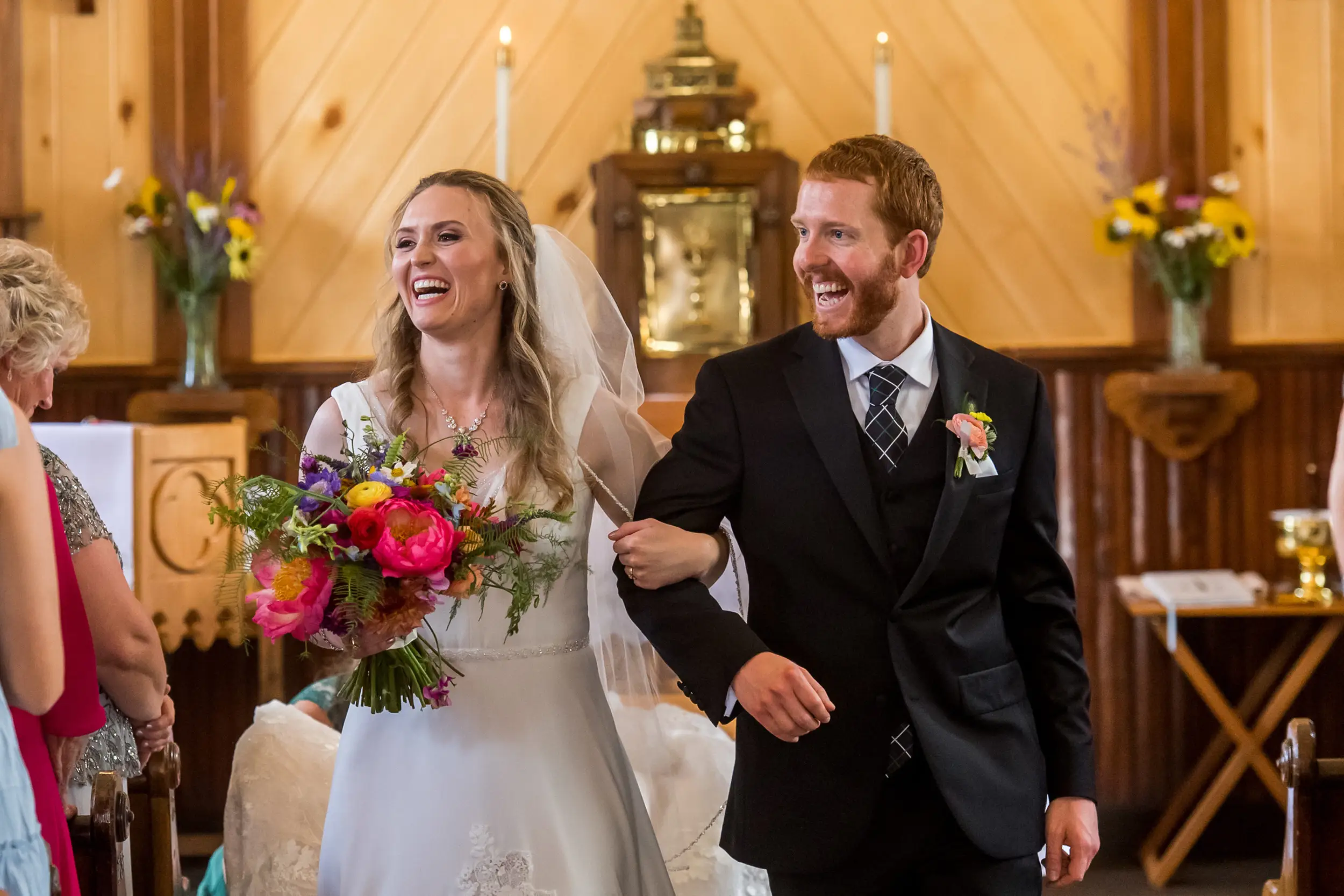 The bride and groom process out of the church after their wedding at St. Patrick's Church Telluride.
