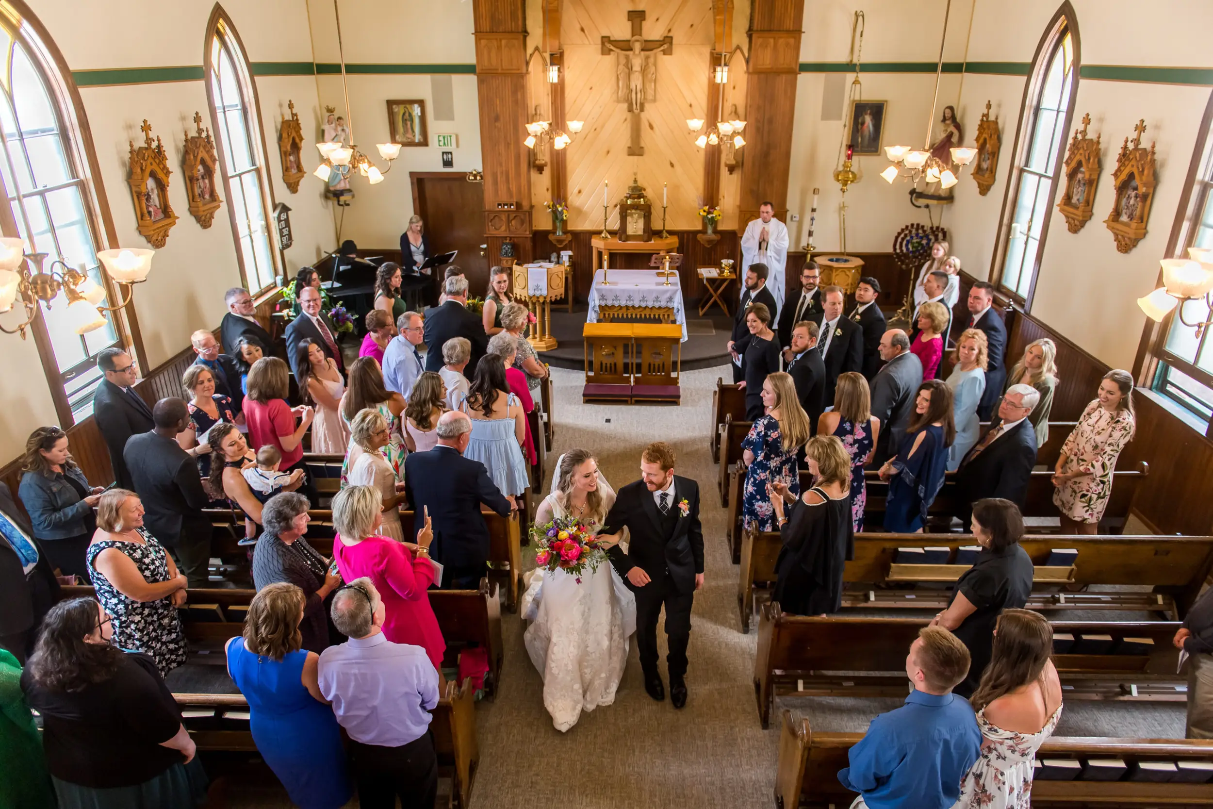 The bride and groom process out of the church after their wedding at St. Patrick's Church Telluride.