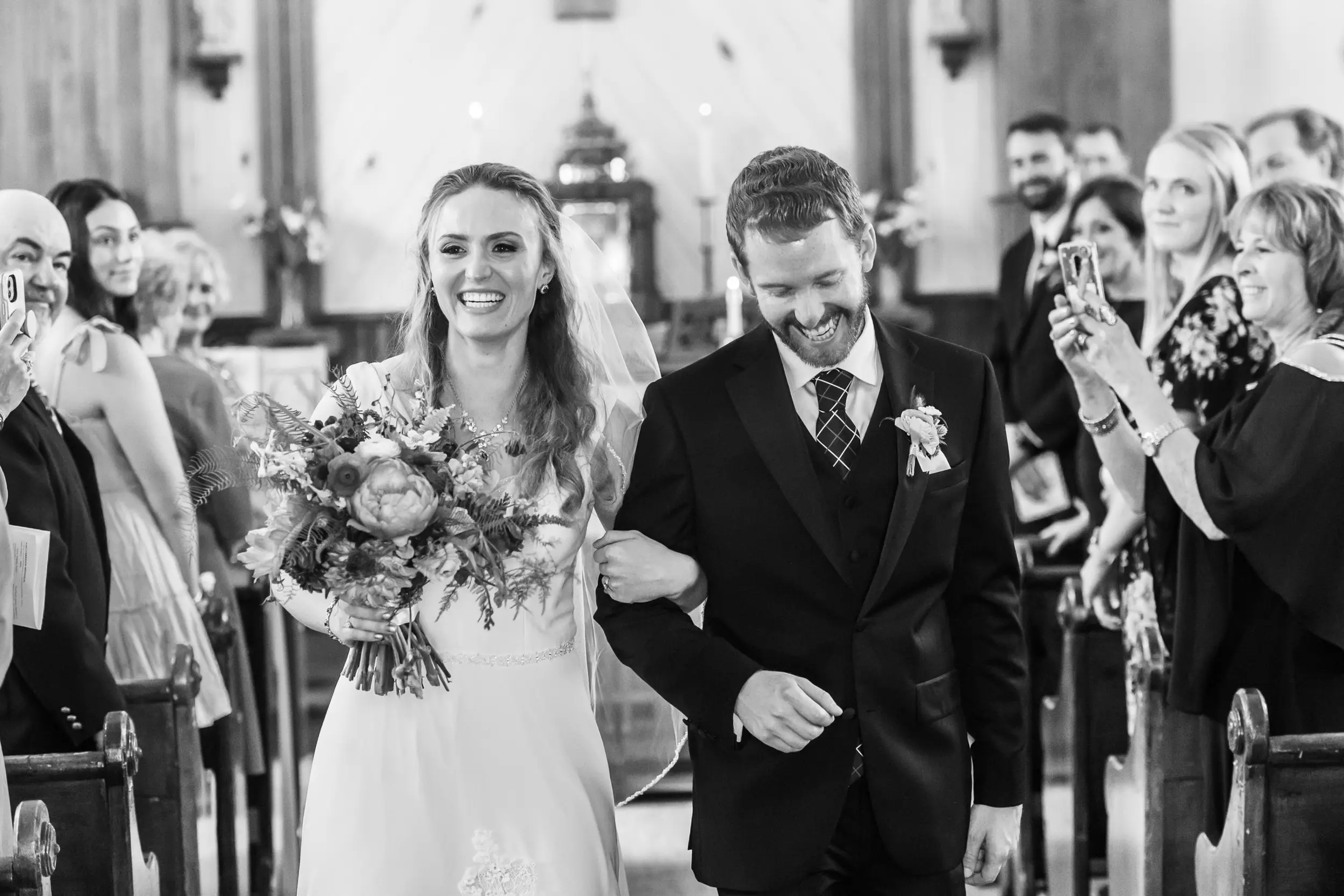 The bride and groom process out of the church after their wedding at St. Patrick's Church Telluride.