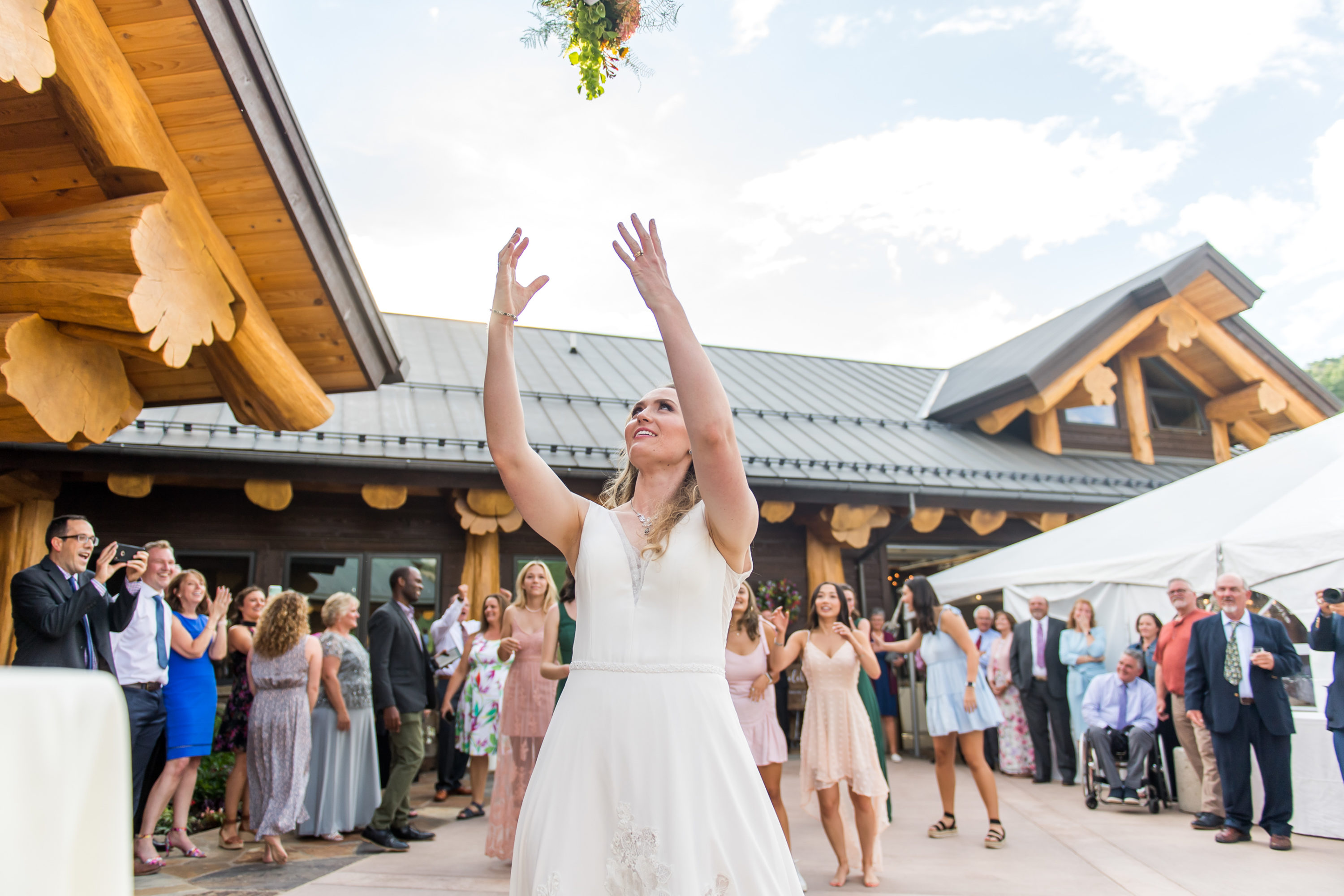 The bride tosses the bouquet during their Telluride, Colorado, wedding.
