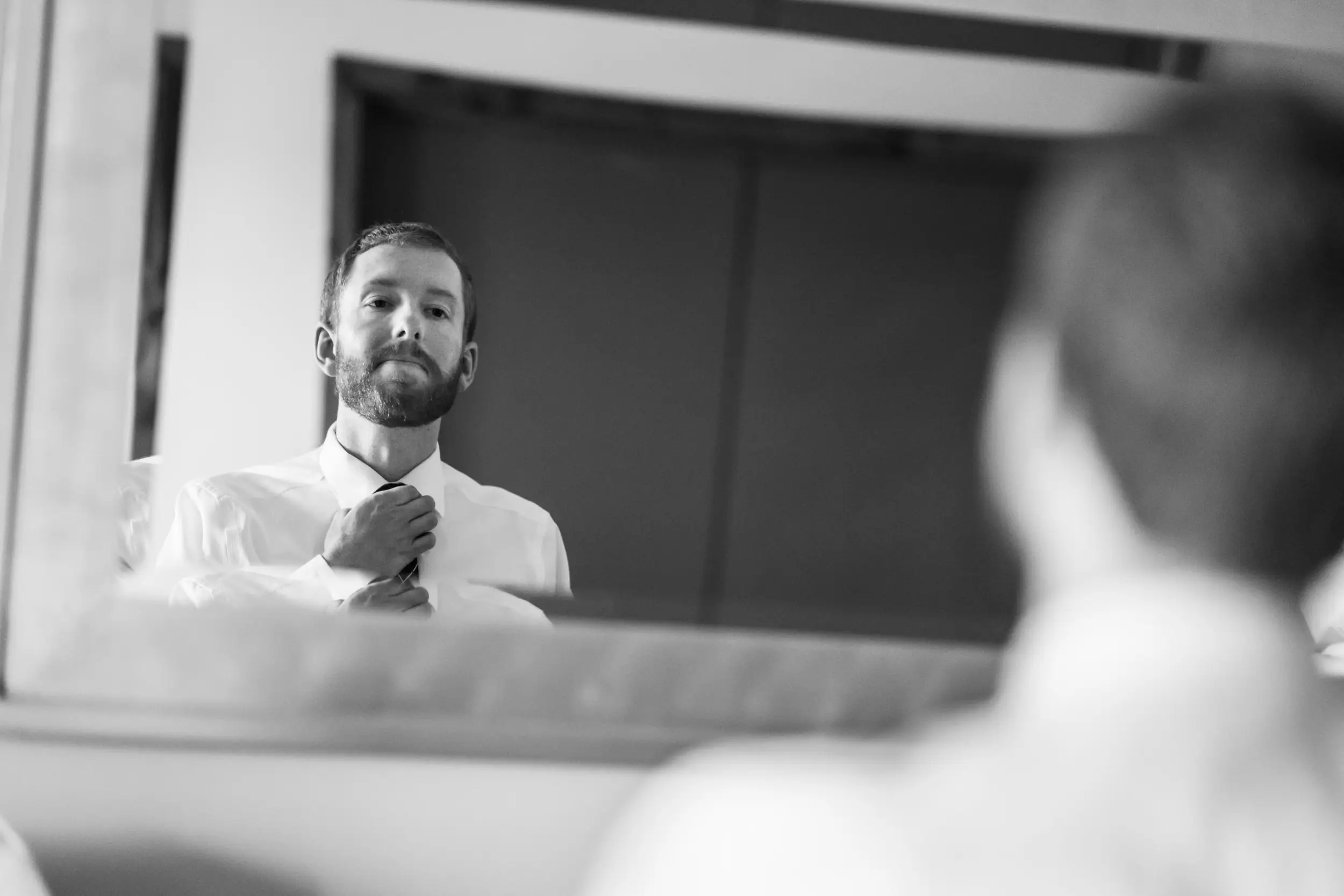 The groom adjusts his tie before his Telluride, Colorado, wedding.