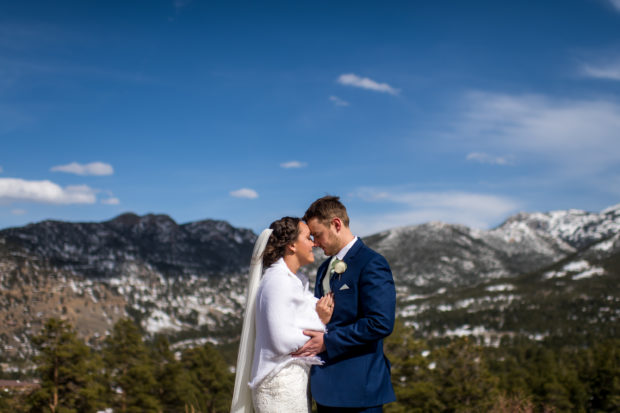 The bride and groom embrace during their YMCA of the Rockies wedding in Estes Park, Colorado.