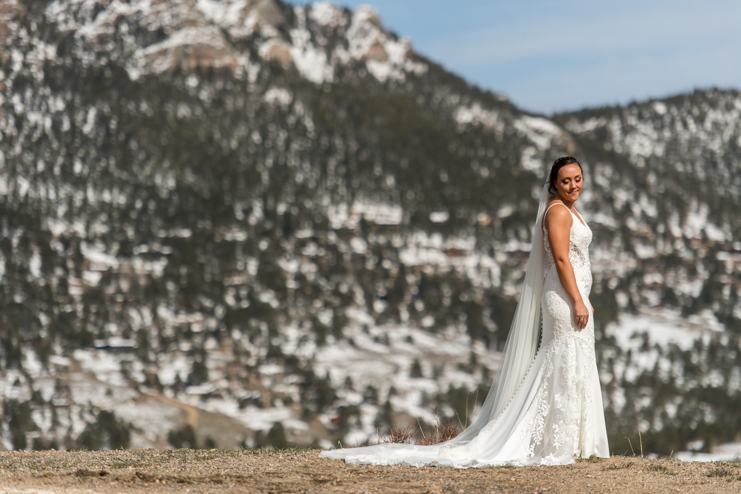 The bride poses during her YMCA of the Rockies wedding in Estes Park, Colorado.
