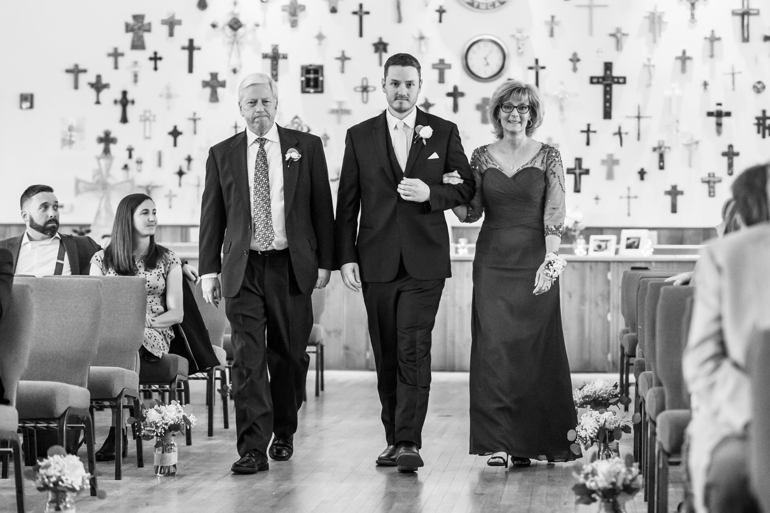 The groom and his parents process in during the YMCA of the Rockies wedding in Estes Park, Colorado.